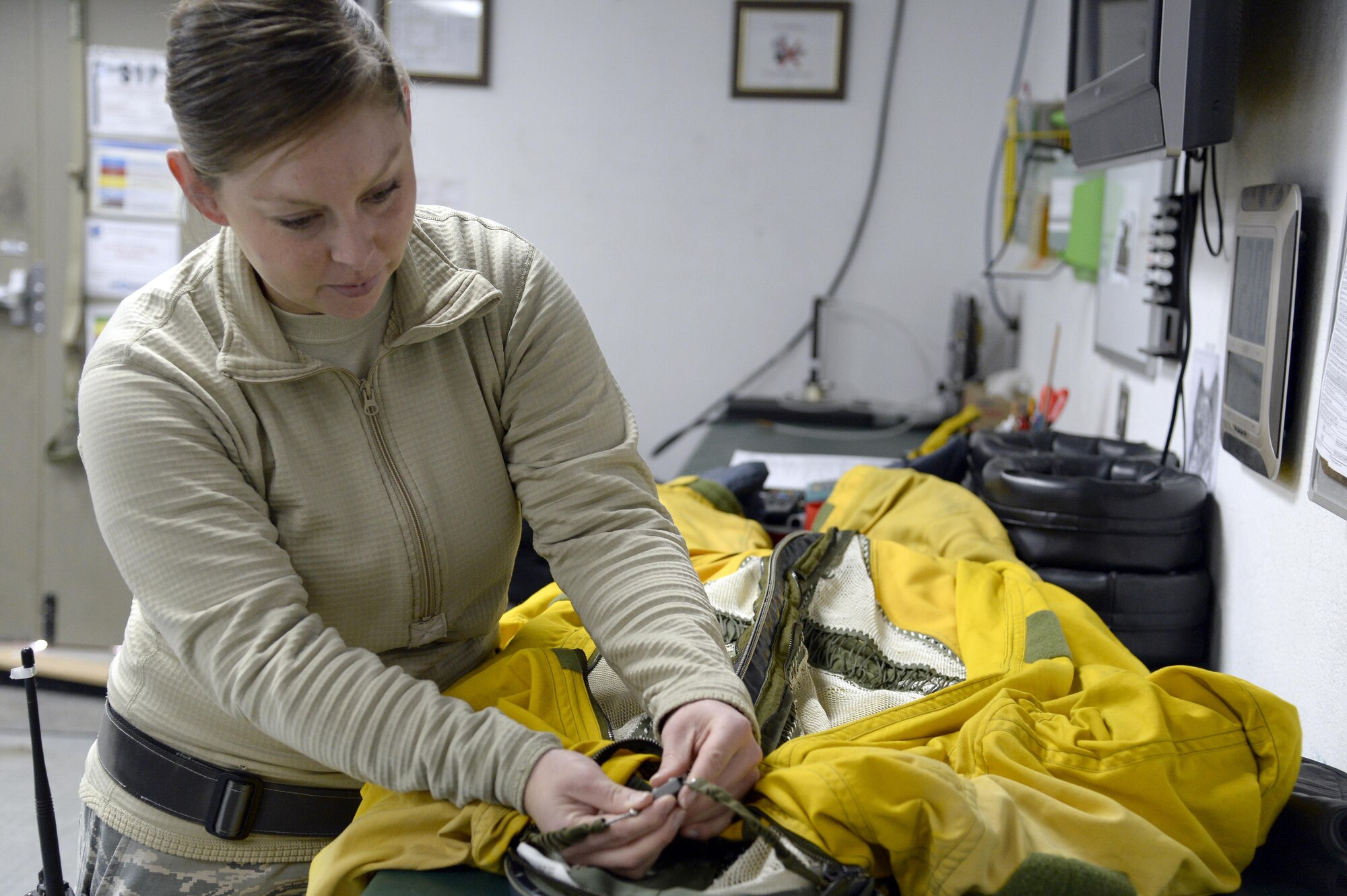 Staff Sgt. Lynette, launch and recovery supervisor, performs a quality assurance check on a full pressure suit at an undisclosed location in Southwest Asia Jan. 20, 2015. The suit is to protect the pilot from decompression sickness and is a backup in case the aircraft loses pressurization. Lynette is currently deployed from Beale Air Force Base, Calif., and is a native of Phillips, Maine. (U.S. Air Force photo/Tech. Sgt. Marie Brown)