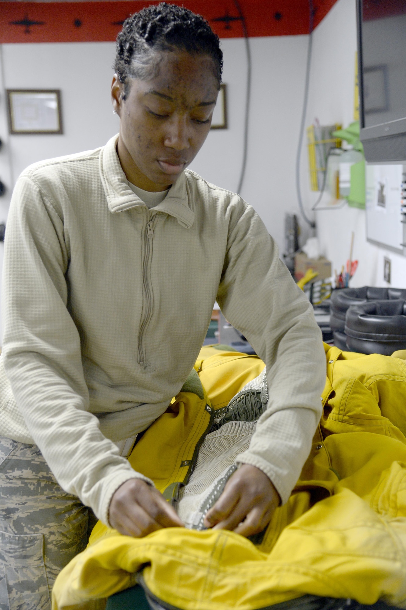 Senior Airman Andrea, launch and recovery technician, performs an inspection on a full pressure suit at an undisclosed location in Southwest Asia Jan. 20, 2015. The mission of the physiological support detachment is to inspect and maintain the full pressure suits necessary for the U-2 Dragon Lady pilot to survive above 50,000 feet and fly up to 70,000 feet. Andrea is currently deployed from Beale Air Force Base, Calif., and is a native of Centerville, Ga. (U.S. Air Force photo/Tech. Sgt. Marie Brown)