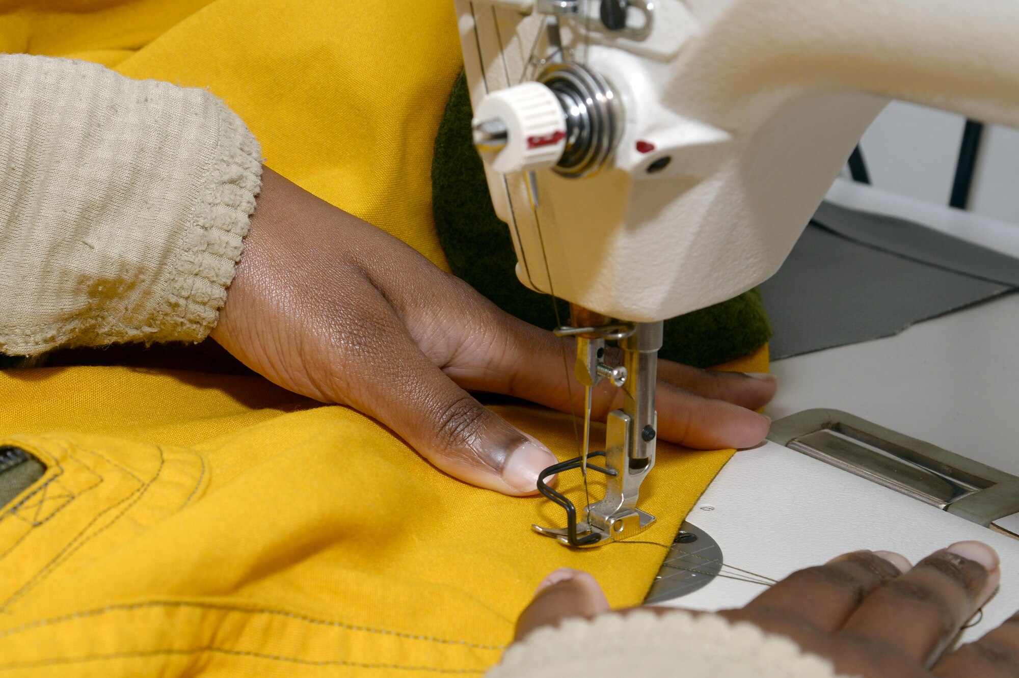 Senior Airman Andrea, launch and recovery technician, repairs a seam on a full pressure suit at an undisclosed location in Southwest Asia Jan. 20, 2015. The suit is to protect the pilot from decompression sickness and is a backup in case the aircraft loses pressurization. Andrea is currently deployed from Beale Air Force Base, Calif., and is a native of Centerville, Ga. (U.S. Air Force photo/Tech. Sgt. Marie Brown)