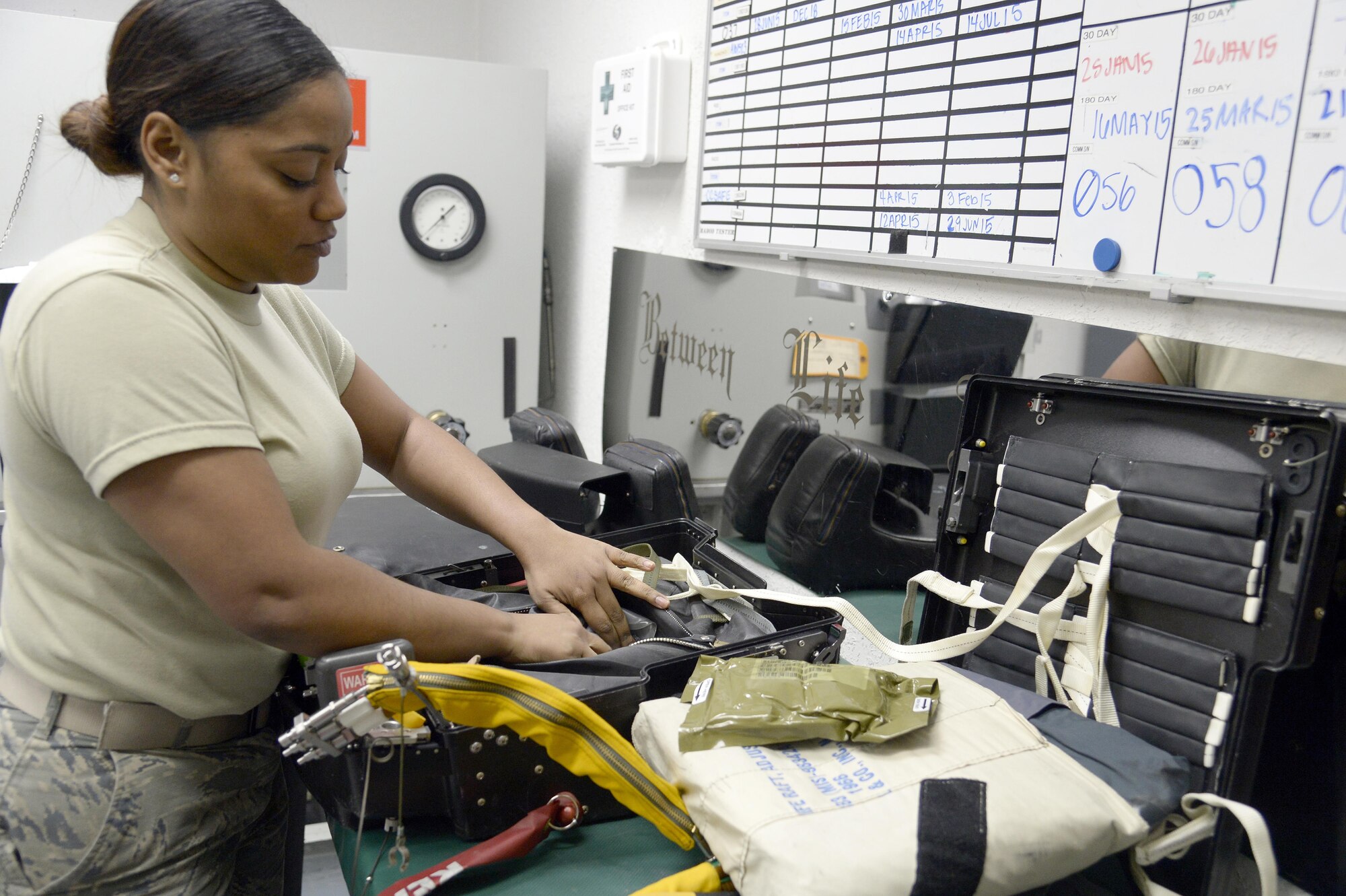 Senior Airman Tamika, launch and recovery technician, inspects the components of a pilot’s seat as part of a 30-day inspection at an undisclosed location in Southwest Asia Jan. 20, 2015. Along with maintaining and inspecting the suit, the physiological support detachment Airmen also maintain and inspect the pilot’s survival kit and its components. Tamika is currently deployed from Beale Air Force Base, Calif. (U.S. Air Force photo/Tech. Sgt. Marie Brown)