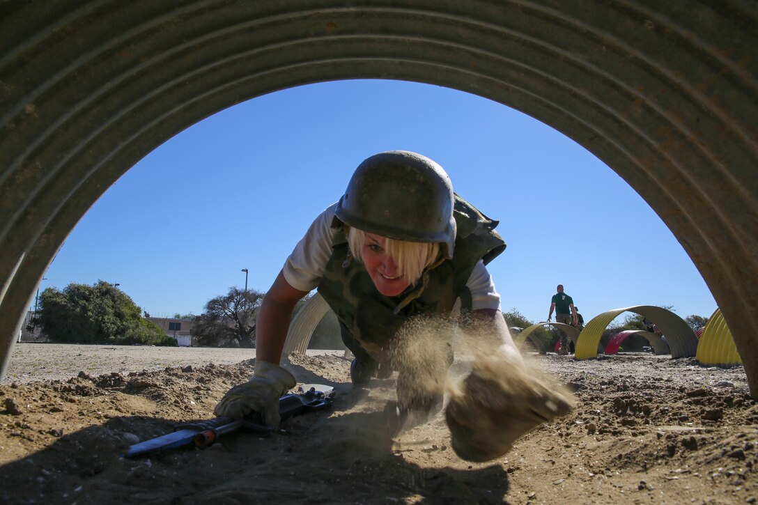 Andrea Stauffer, marketing chief, Family and Morale, Welfare, and Recreation, United States Army Garrison, crawls through a tunnel during the Bayonet Assault Course at Marine Corps Recruit Depot San Diego, Jan. 6.  The ELDP group consisted of Department of Defense employees from all facets of the organization.