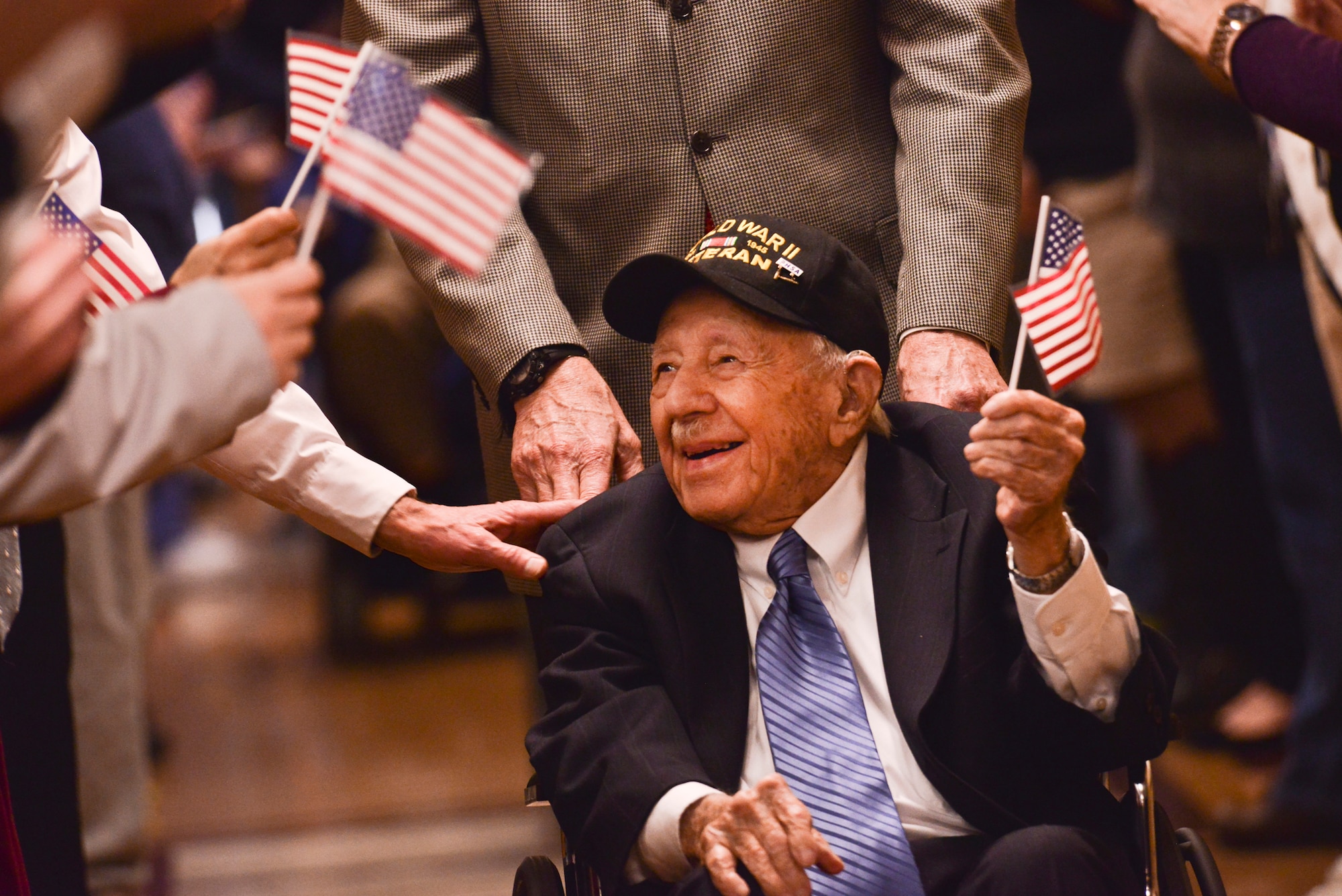 George “Bud” Garvin, U.S. Army Air Corps and Air Force veteran, is greeted by friends, family and staff members lining the hallways for his 100th birthday celebration at Spokane Veterans medical Center, Jan. 21, 2015, Spokane, Wash. Garvin, while serving, endured the attack on Pearl Harbor, the invasion at Omaha Beach and fought in the Battle of the Bulge. (U.S. Air Force photo by Staff Sgt. Alexandre Montes)