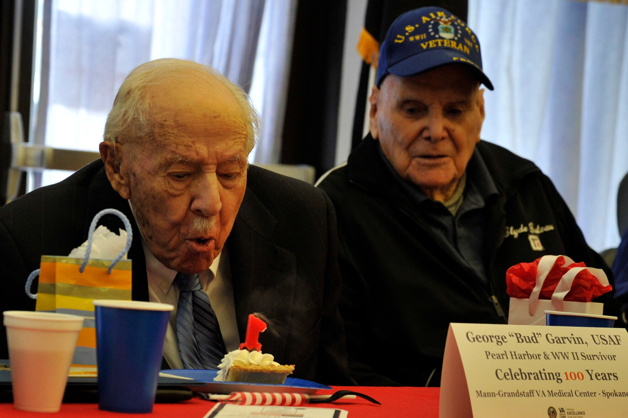 George “Bud” Garvin, veteran of the U.S. Army Air Corps and Air Force, blows out his birthday candle during his birthday celebration at the Spokane VA Medical Center Jan. 21, 2015, Spokane, Wash. The Spokane VAMC hosted his 100th birthday celebration and honored him for his military service during; Pearl Harbor, D-Day invasion at Omaha beach and the Battle of the Bulge during World War II. (U.S. Air Force photo/Airman 1st Class Nicolo J. Daniello)