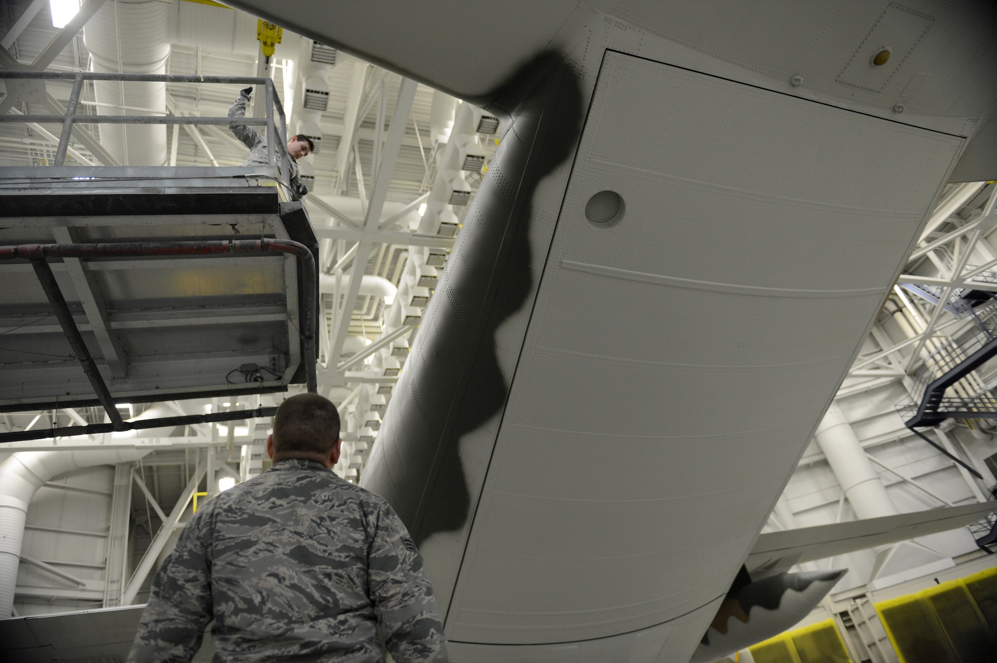 Senior Airman Justin Lounder and Senior Airman Matthew Beehler, 62nd Maintenance Squadron aircraft structural maintenance technicians repaint a C-130 Hercules Jan. 13, 2015, at Joint Base Lewis-McChord, Wash. Airmen from the 62nd MXS spent more than two months repainting a C-130 Hercules in Vietnam era camouflage scheme.  The aircraft was painted for the McChord Air Museum. (U.S. Air Force photo/Airman 1st Class Keoni Chavarria)