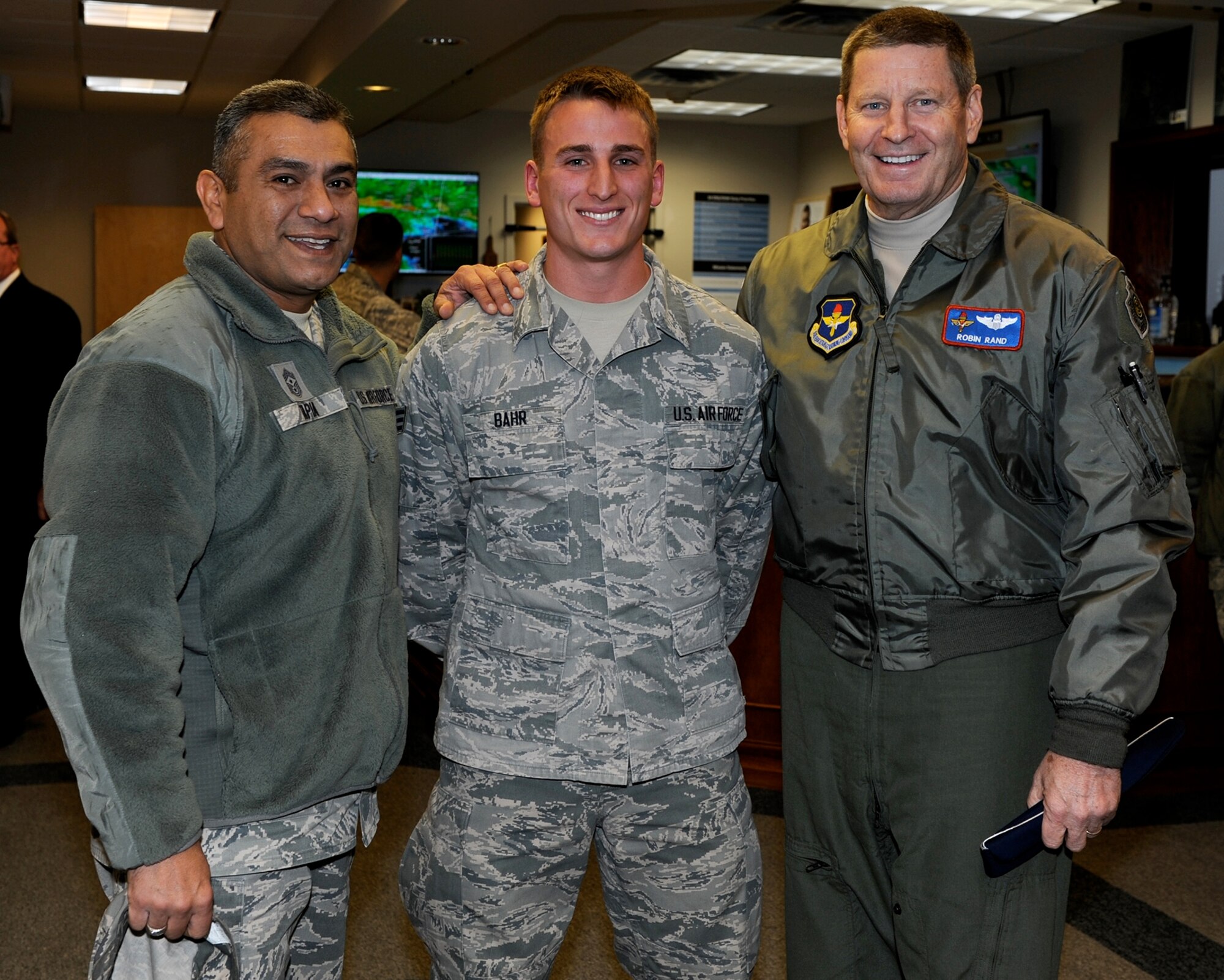 Gen. Robin Rand, Commander of Air Education and Training Command (right), and Chief Master Sgt. Gerardo Tapia, AETC Command Chief, take a photo with Airman 1st Class Nicholas Bahr, 14th Operations Support Squadron member, upon their arrival to Columbus Air Force Base, Miss., Jan. 22. The general and chief master sergeant visited the 14th Flying Training Wing Jan. 22 and 23. (U.S. Air Force photo/Elizabeth Owens)
