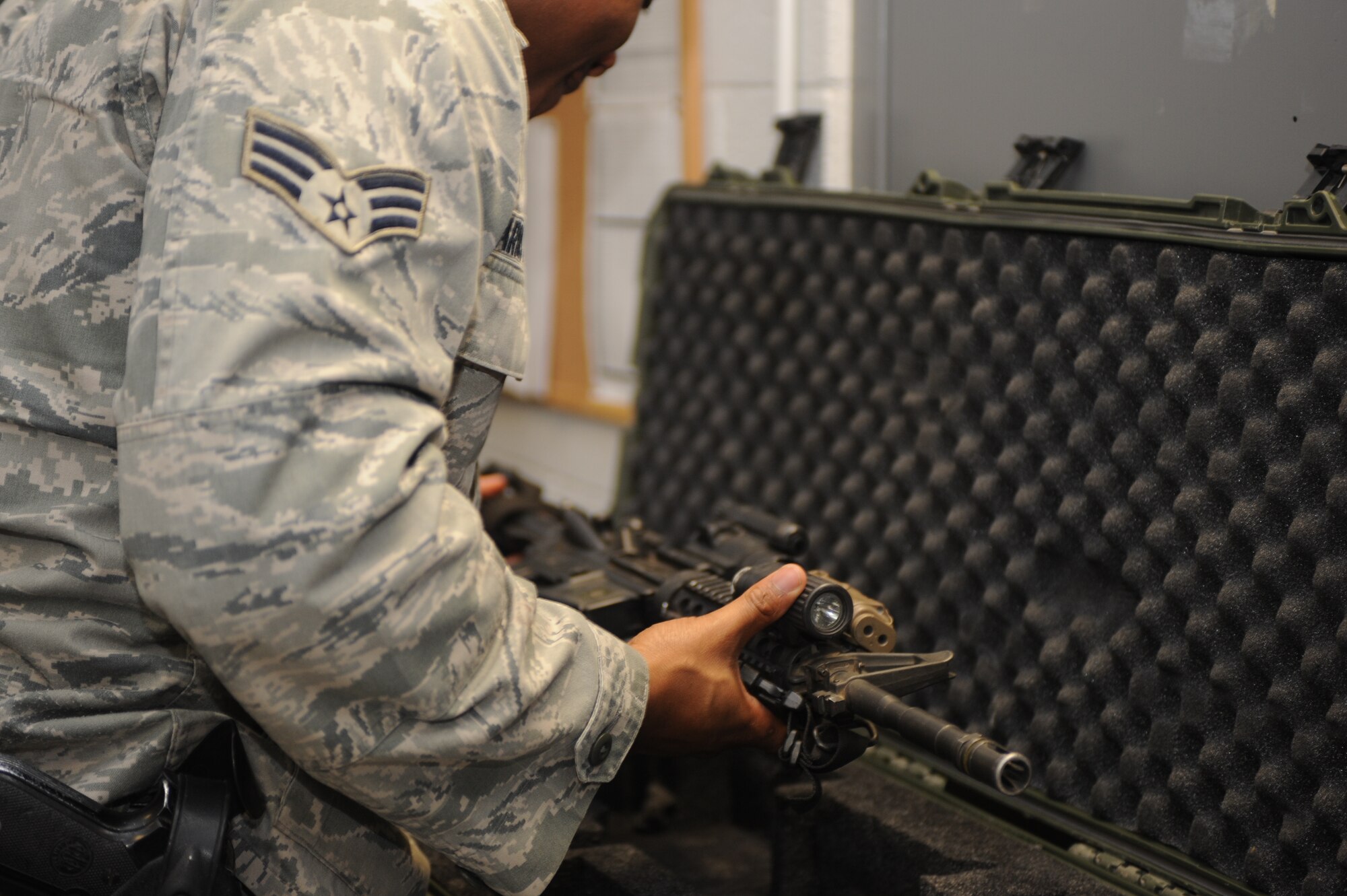 U.S. Air Force Senior Airman Deiron Armstead, 355th Security Forces Squadron arms room attendant, inspects an M4 carbine rifle for potential causes of malfunctions at the armory at Davis-Monthan Air Force Base, Ariz., Jan. 20, 2015. All deployment case weapons must be inspected prior to being issued to outbound Security Forces Squadron personnel. (U.S. Air Force photo by Airman 1st Class Cheyenne Morigeau/Released) 