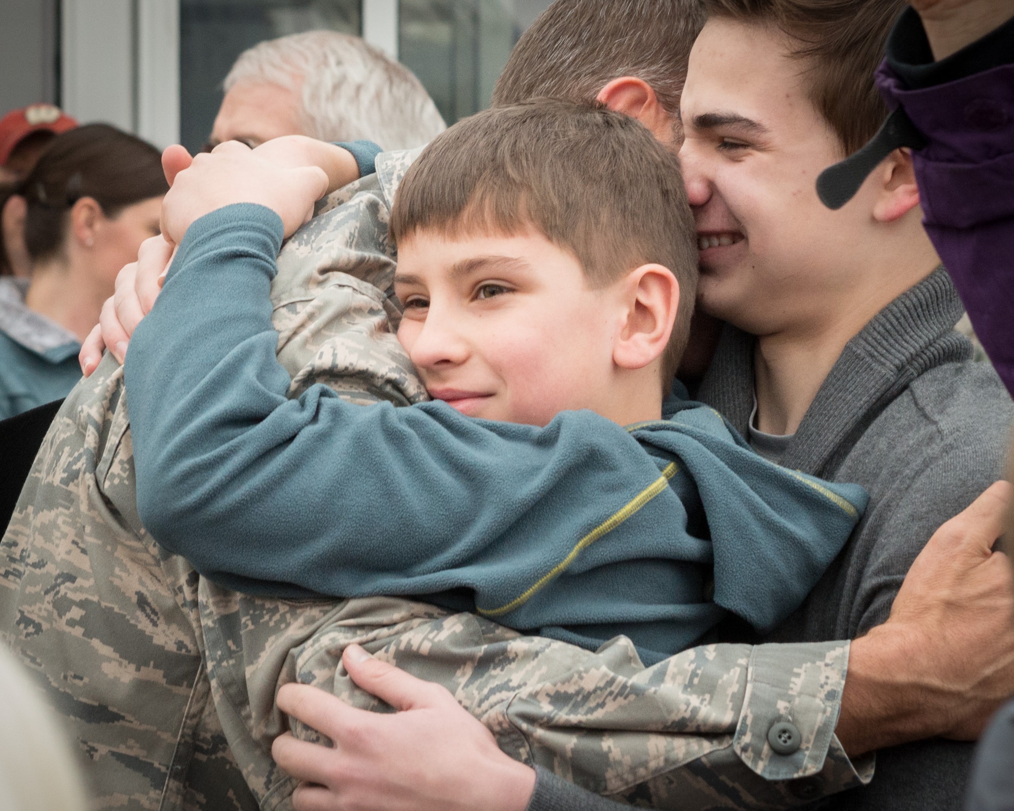 Master Sgt. William Muller, 934th Maintenance Squadron, greets his family for the first time since September.  Members of the 934th Airlift Wing, friends, and family welcomed home their Airmen as they returned back from deployment overseas to the Minneapolis-St. Paul Air Reserve Station, Minn., Jan. 20.  (U.S. Air Force photo by Shannon McKay/Released)