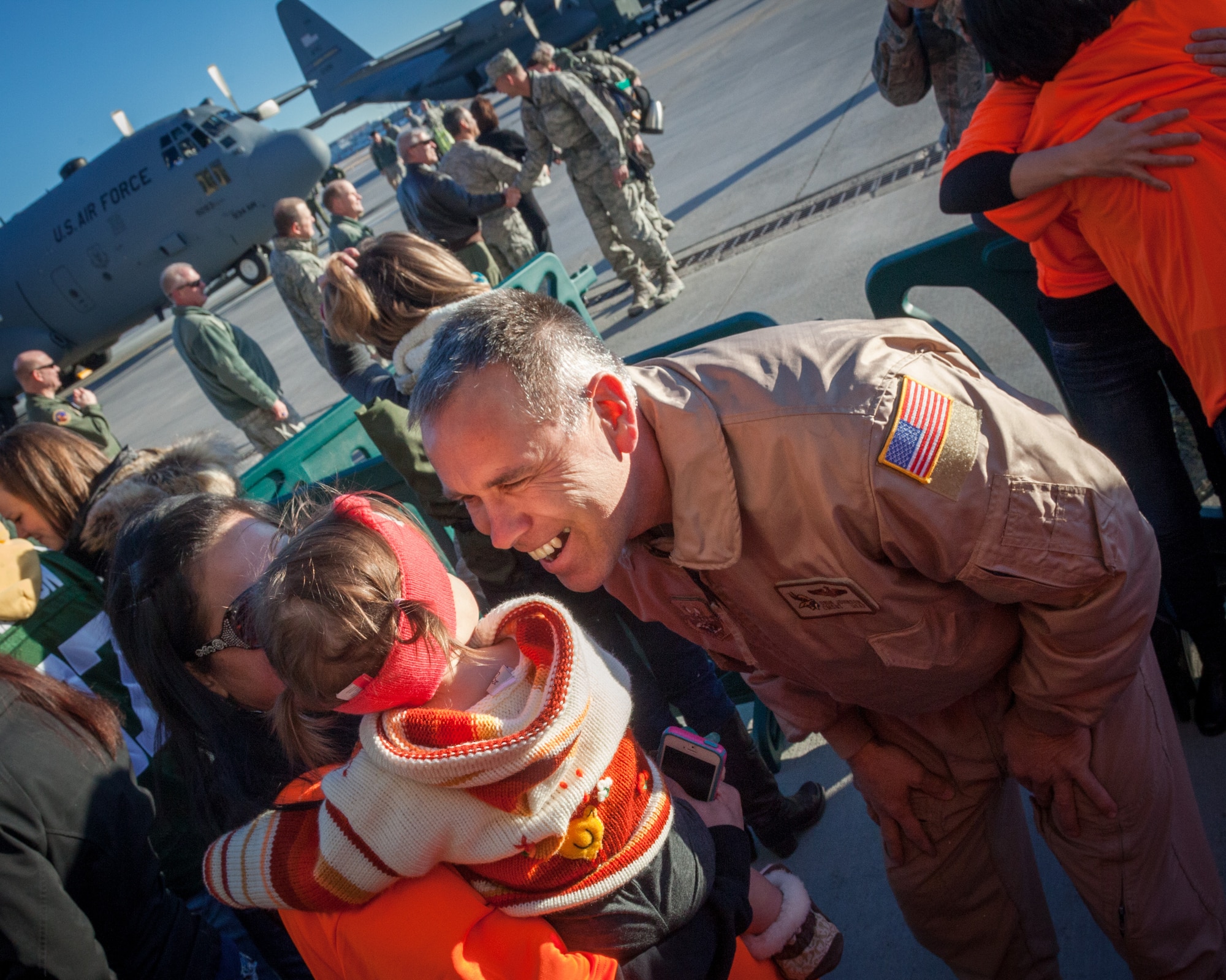 Chief Master Sgt. Orin Johnson, 934th Operations Group, smiles at his friends and family that came to greet him home.  Members of 934th Airlift Wing, friends, and family welcomed home their Airmen as they returned from deployment overseas to the Minneapolis-St. Paul Air Reserve Station, Minn., Jan. 18.  (U.S. Air Force photo by Shannon McKay/Released)