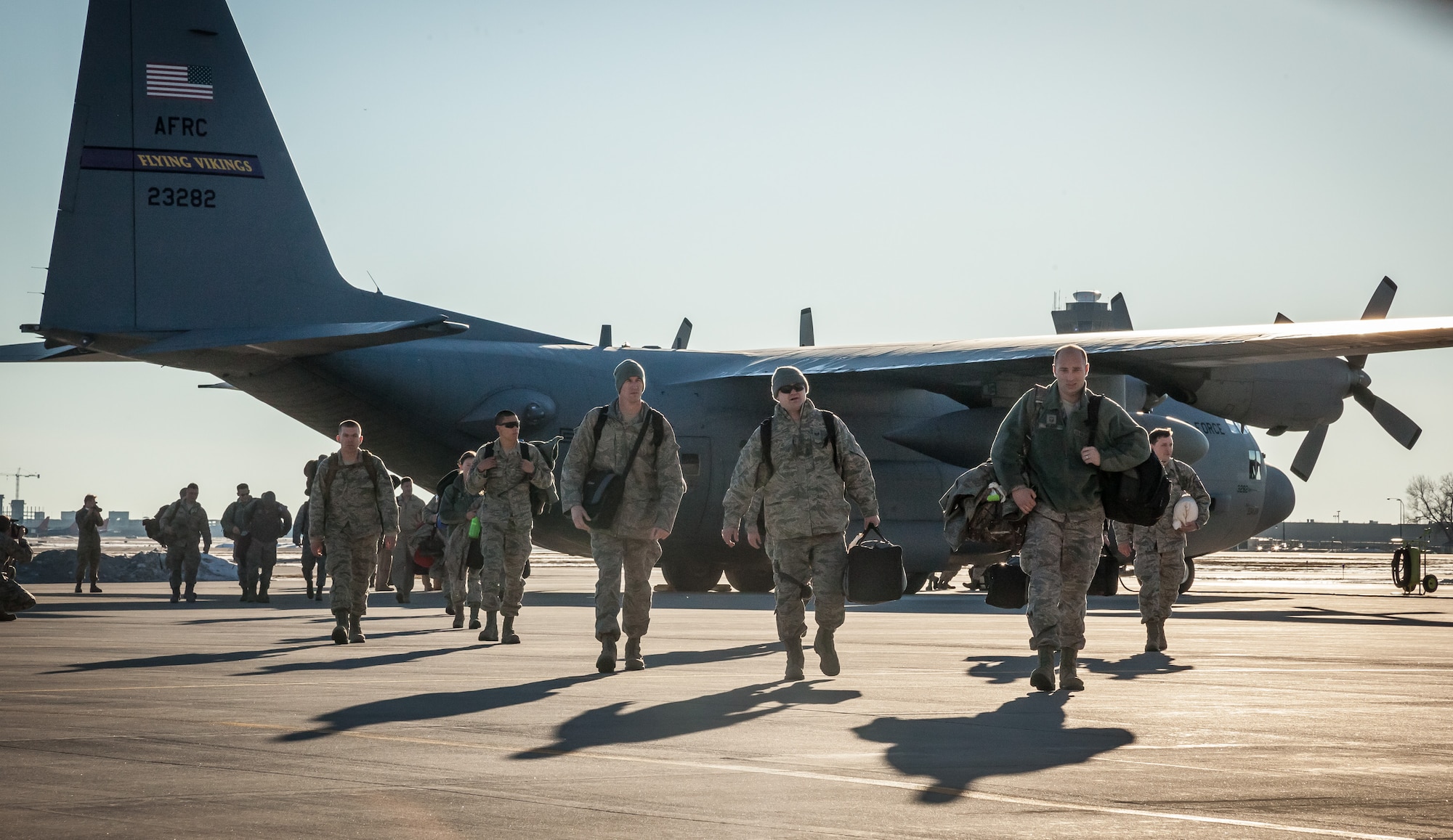 Airmen from the 934th Airlift Wing exit the aircraft as they are welcomed home by friends, family, and fellow Airmen as they return from deployment to the Minneapolis-St. Paul Air Reserve Station, Minn., Jan. 18.  (U.S. Air Force photo by Shannon McKay/Released)
