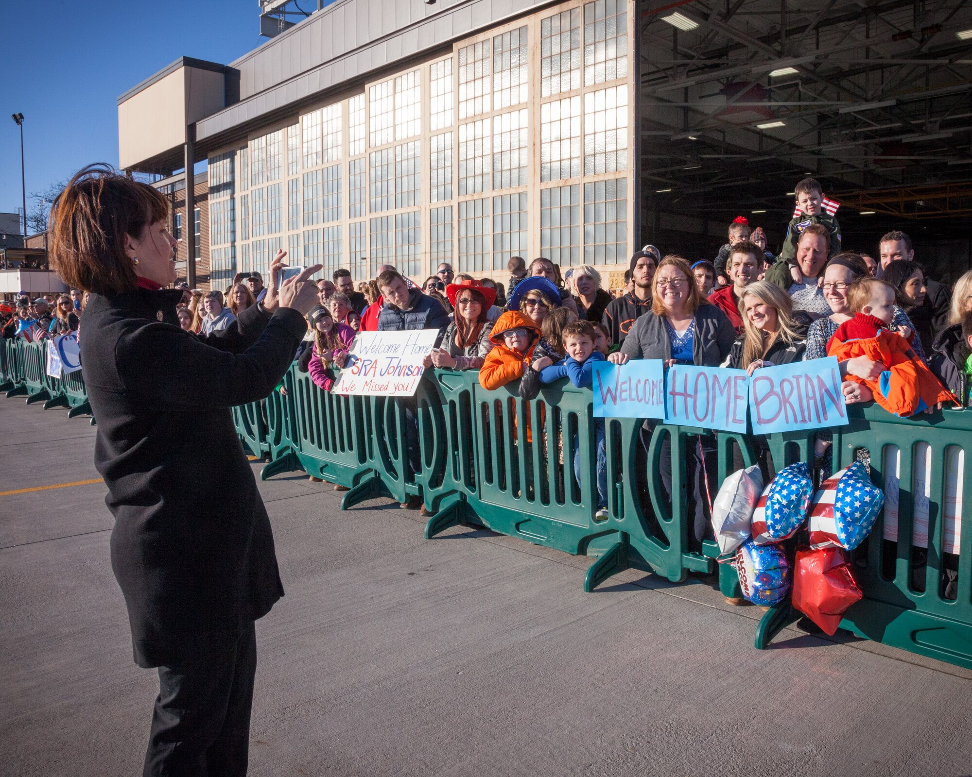 Congresswoman Betty McCollum takes a photo for friends and family as they await the return of their Airmen from deployment overseas.  The 934th Airlift Wing, friends, and family welcomed home their Airmen as they returned from deployment at the Minneapolis-St. Paul Air Reserve Station, Minn.  (U.S. Air Force photo by Shannon McKay/Released)