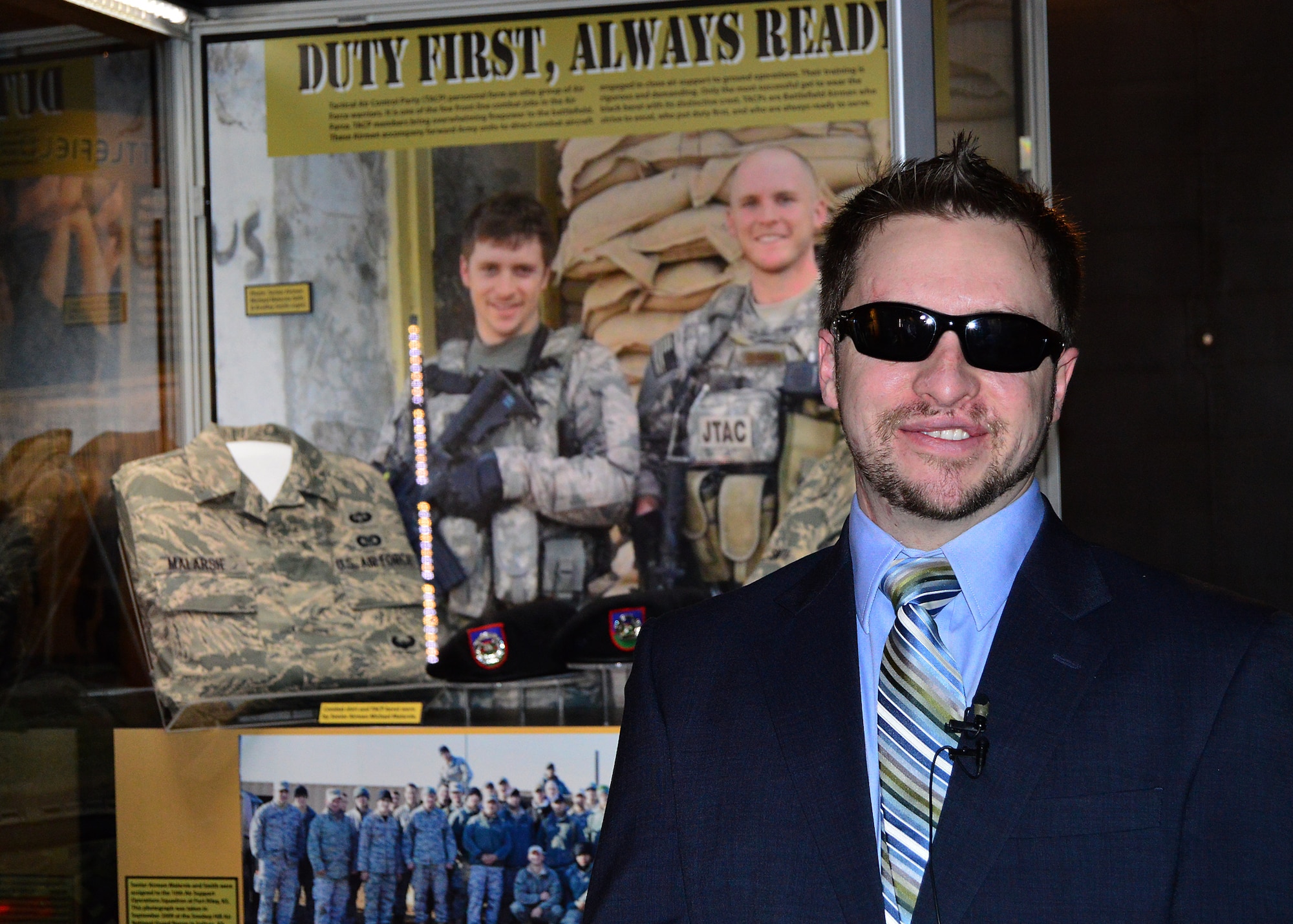 DAYTON, Ohio -- SSgt.(Ret.) Mike Malarsie smiles at the media in front of the "Duty First, Always Ready" exhibit. This exhibit is located in the Cold War Gallery at the National Museum of the U.S. Air Force, highlights the service of Senior Airmen Michael Malarsie and Bradley Smith, a two-man Joint Terminal Attack Controller (JTAC) who deployed together to Afghanistan in December 2009. (U.S. Air Force photo)