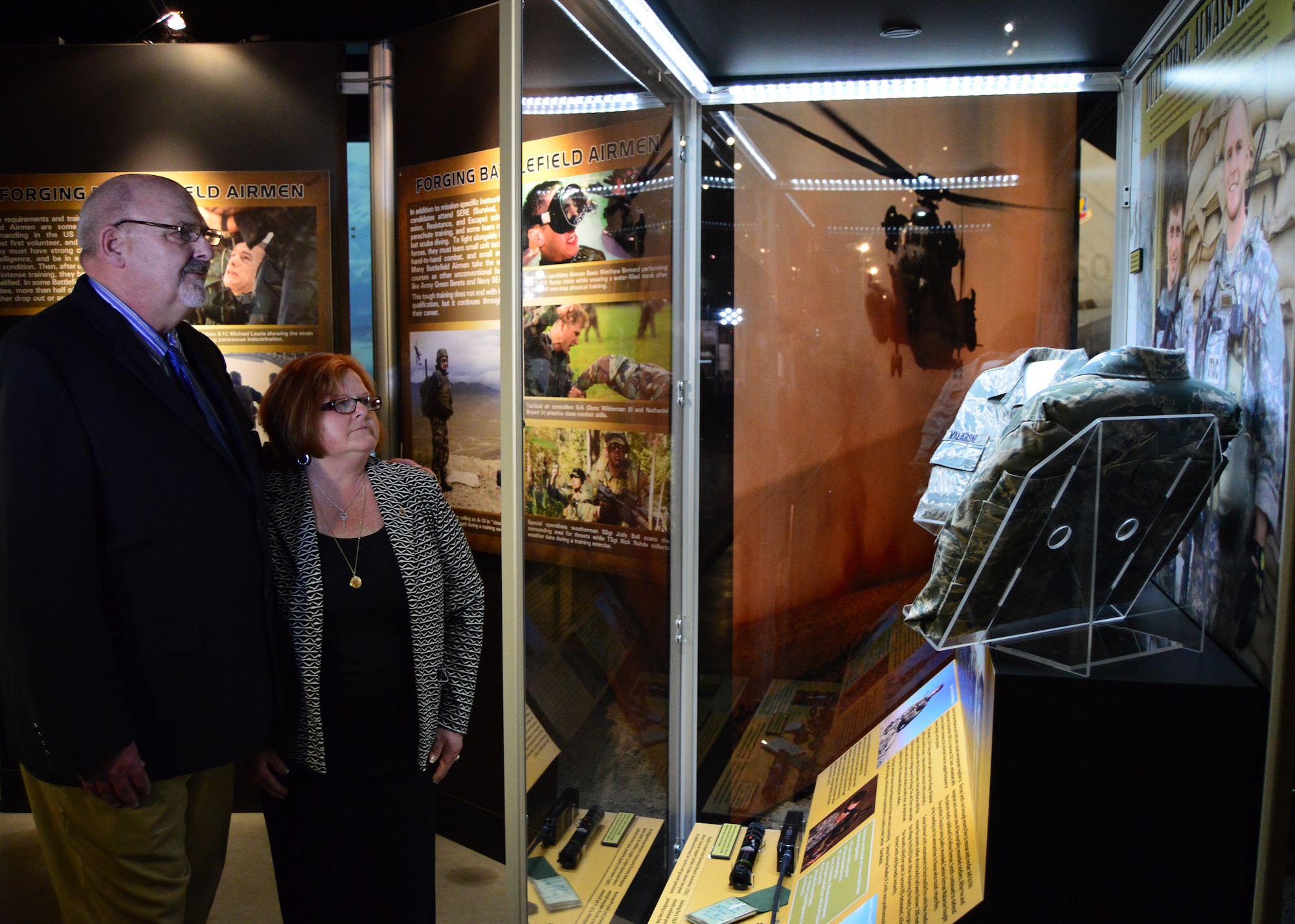 DAYTON, Ohio -- Parents of SrA Smith view the "Duty First, Always Ready" exhibit where their son and SrA Malarsie are represented. This exhibit located in the Cold War Gallery at the National Museum of the U.S. Air Force, highlights the service of Senior Airmen Michael Malarsie and Bradley Smith, a two-man Joint Terminal Attack Controller (JTAC) who deployed together to Afghanistan in December 2009. (U.S. Air Force photo) 

