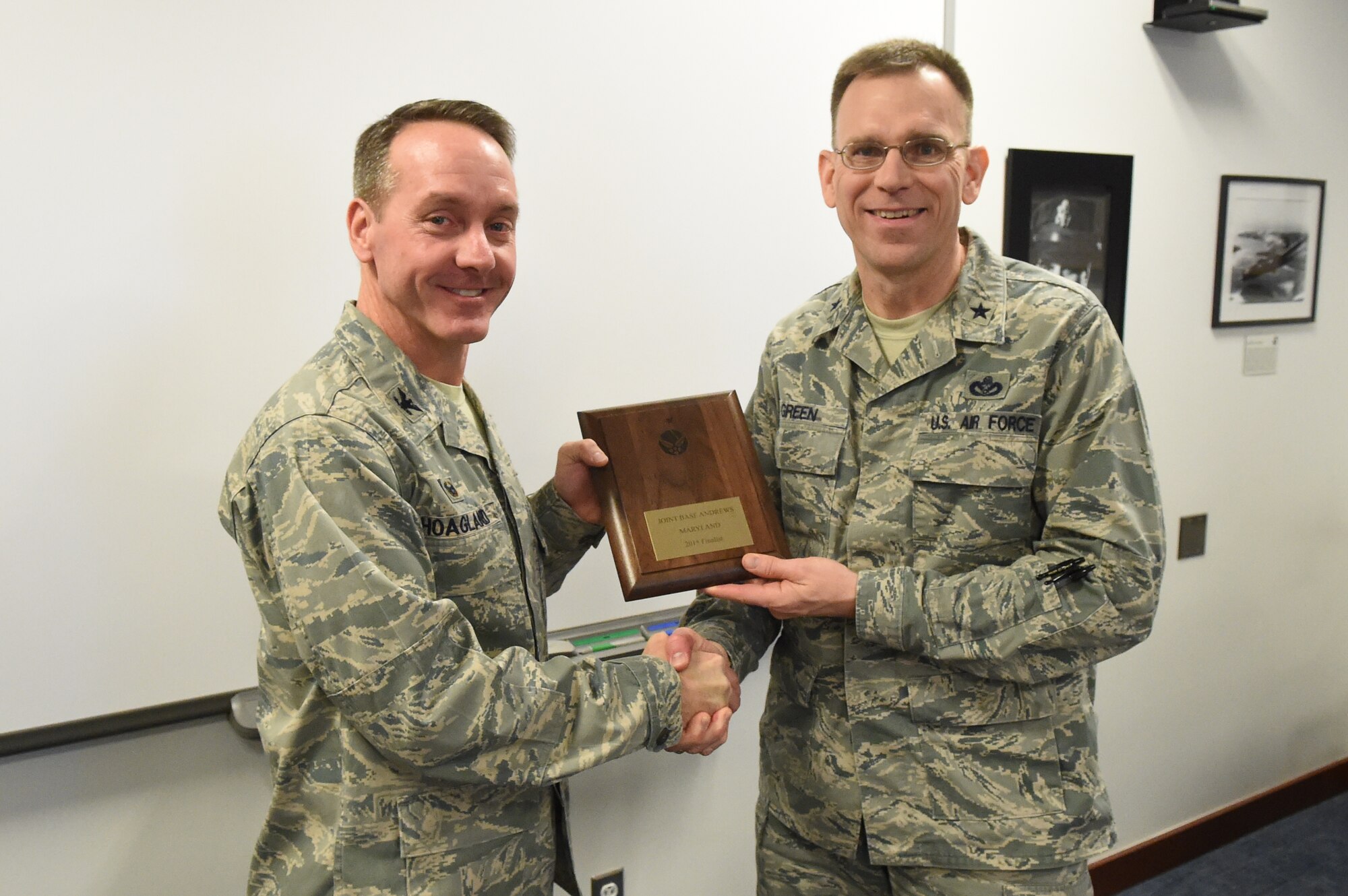 Col. Brad Hoagland, 11th Wing/Joint Base Andrews commander, receives a plaque from Brig. Gen. Timothy Green, Air Force Director of Civil Engineers, for JBA being one of the finalists for the Commander-in-Chief’s Installation Excellence Award at JBA, Md., Jan. 12, 2015. (U.S. Air Force photo/Airman 1st Class Joshua R. M. Dewberry)