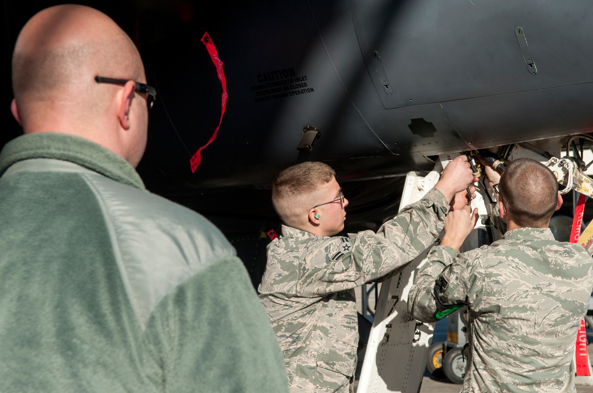 Tech. Sgt. David Todd, 4th Maintenance Group weight and balance manager, evaluates Airman 1st Class Andrew Moesner and Senior Airman Drew Metzger, both crew chiefs from the 4th Aircraft Maintenance Squadron, during a Dedicated Eagle Keeper competition at Seymour Johnson Air Force Base, North Carolina, Jan. 16, 2015. The results of the competition will be officially announced Feb. 20 during a ceremony with awards presented by Col. Darrell Steele, 4th MXG commander. (U.S. Air Force photo/Airman Shawna L. Keyes)