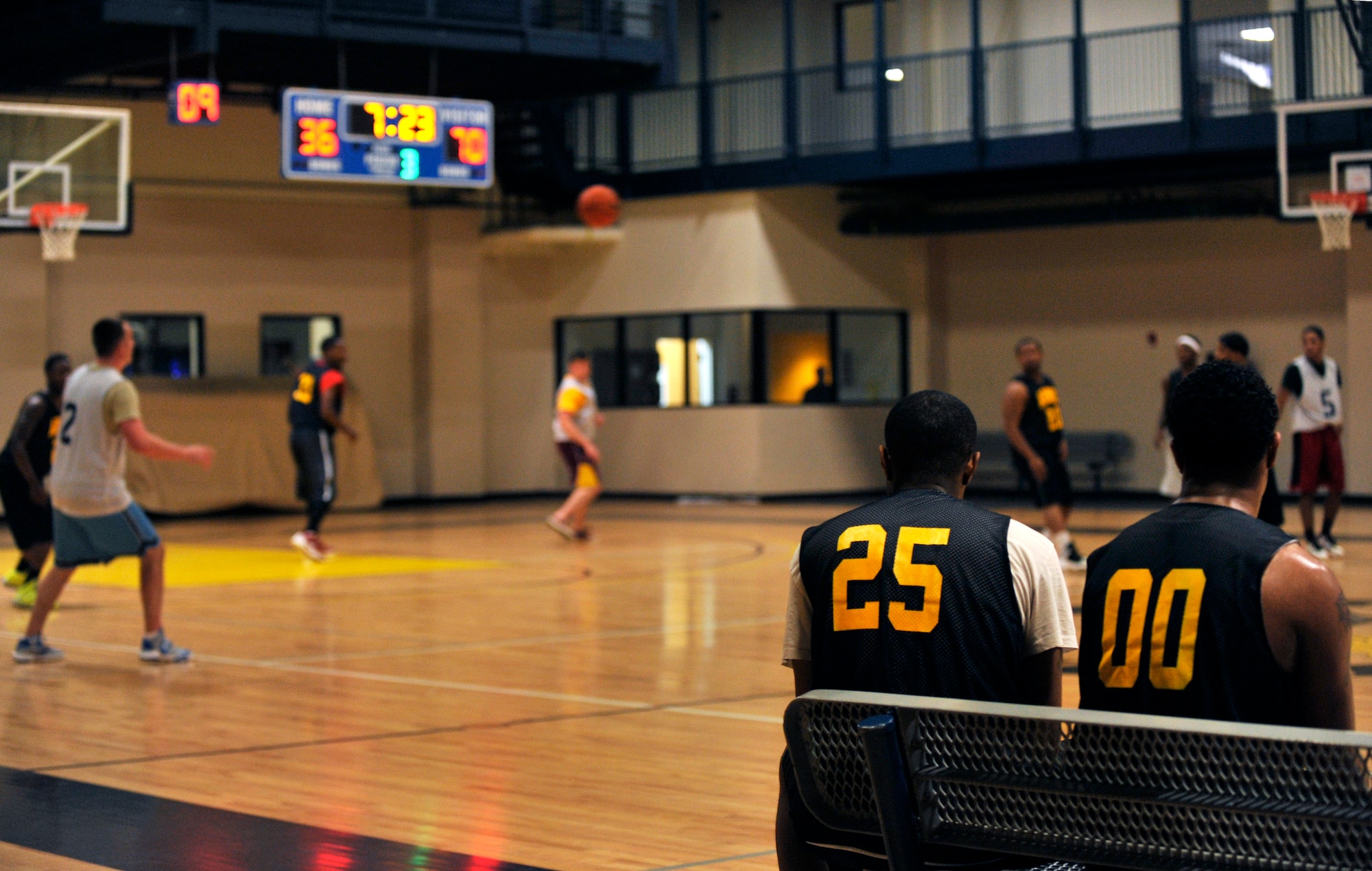 Team members of the Army National Guard watch the final seven minutes of the 7:30 p.m. intramural basketball game Jan. 15, 2015, at Little Rock Air Force Base, Ark. Each Monday, Tuesday, Wednesday and Thursday, games are played at 5:30, 6:30 and 7:30 p.m. (U.S. Air Force photo by Senior Airman Stephanie Serrano) 
