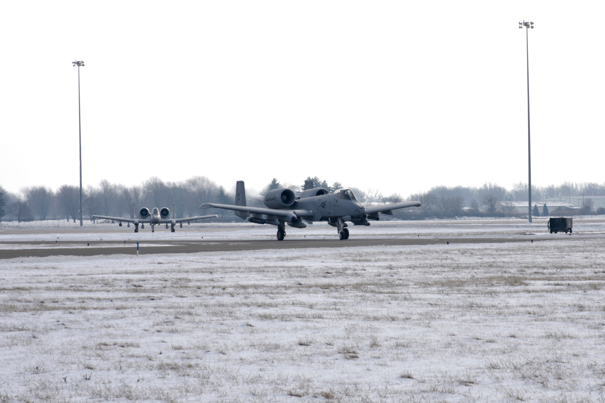 A-10 Thunderbolt II aircraft taxi as the 107th Fighter Squadron prepares to takeoff to Operation Snowbird at Davis-Monthan AFB, Ariz., on Friday, January 23.   Operation Snowbird allows military flying units to take advantage of the optimal weather conditions and live-fire ranges available in southern Arizona during the winter months, when home station training may be hampered by snow and ice. About 200 Airmen and 10 aircraft from the 127th Wing deployed and will support this year's operation.  (U.S. Air National Guard photo by Brittani Baisden)