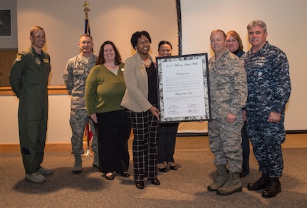 Col. Jeffrey DeVore, Joint Base Charleston commander, Capt. Timothy Sparks, JB Charleston deputy commander, Col. John Lamontagne, 437th Airlift Wing commander, and Col. James J. Fontanella, 315th Airlift Wing commander, present Angela Cottman, 628th Force Support Squadron Fleet and Family Support Center work-life consultant, with the signed Military Saves Week proclamation letter Jan. 23, 2015, at the JB Charleston Education Center auditorium. Military Saves, a component of America Saves and a partner in the DoD Financial Readiness Campaign, is a research-based social marketing campaign intended to motivate, support, and encourage military families to save money and build wealth.  (U.S. Air Force photo/ Senior Airman Dennis Sloan)
