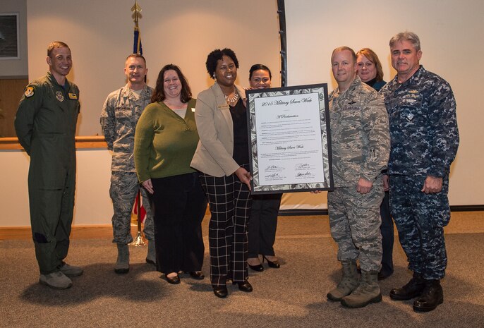 Col. Jeffrey DeVore, Joint Base Charleston commander, Capt. Timothy Sparks, JB Charleston deputy commander, Col. John Lamontagne, 437th Airlift Wing commander, and Col. James J. Fontanella, 315th Airlift Wing commander, present Angela Cottman, 628th Force Support Squadron Fleet and Family Support Center work-life consultant, with the signed Military Saves Week proclamation letter Jan. 23, 2015, at the JB Charleston Education Center auditorium. Military Saves, a component of America Saves and a partner in the DoD Financial Readiness Campaign, is a research-based social marketing campaign intended to motivate, support, and encourage military families to save money and build wealth.  (U.S. Air Force photo/ Senior Airman Dennis Sloan)