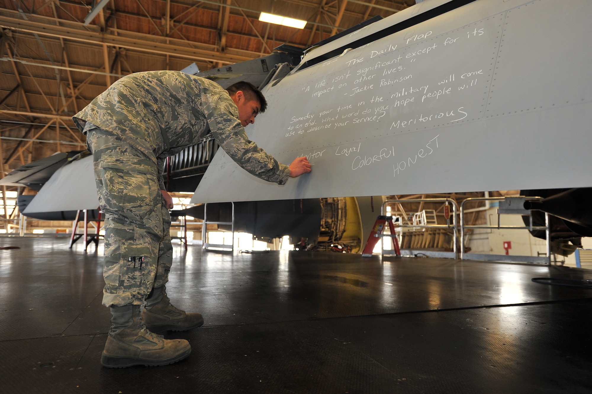 Airman Max Ramos, 92nd Maintenance Squadron crew chief, responds to the question of the day on the ‘daily flap’ Jan. 10, 2015, at Fairchild Air Force Base, Wash. The ‘daily flap’ is a mentoring initiative that began about six months ago. The question of the day was ‘how do you want people to remember your service?’ (U.S. Air Force photo/Staff Sgt. Veronica Montes)   