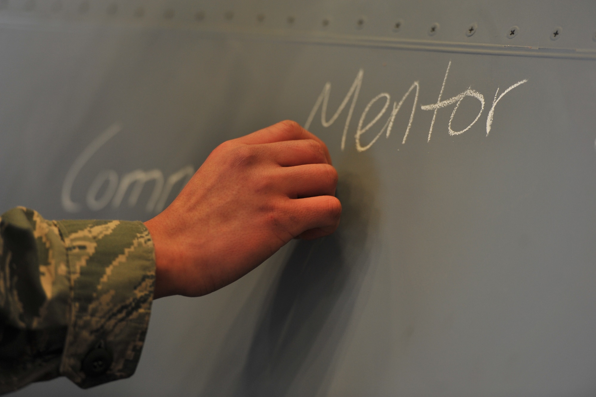 Airman Max Ramos, 92nd Maintenance Squadron crew chief, responds to the question of the day on the ‘daily flap’ Jan. 10, 2015, at Fairchild Air Force Base, Wash. The ‘daily flap’ was created by Tech. Sgt. Eric Laflin, 141st MXS aircraft inspector about six months ago as a tool to motivate and mentor Airmen. (U.S. Air Force photo/Staff Sgt. Veronica Montes)   