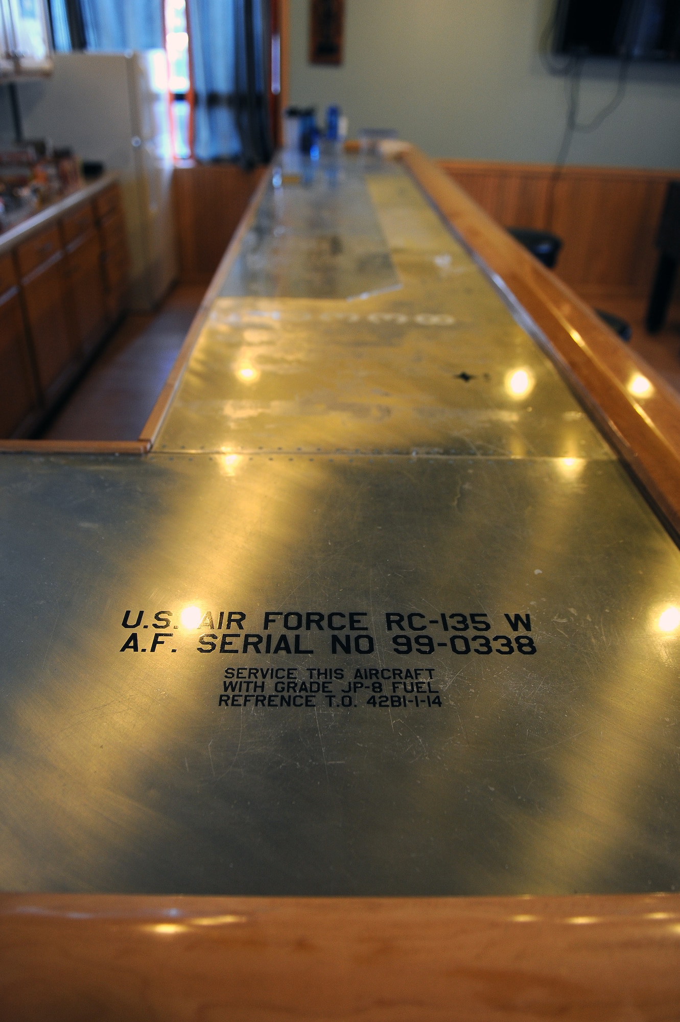 The 338th Combat Training Squadron’s heritage room boasts an impressive hand crafted bar with sheets of metal resembling airframe rivets, Jan. 20, Offutt Air Force Base, Neb.  The room is now shared with Royals Air Force crew members since they’ve been training side-by-side with Airmen from Team Offutt. (U.S. Air Force photo by Josh Plueger/Released)