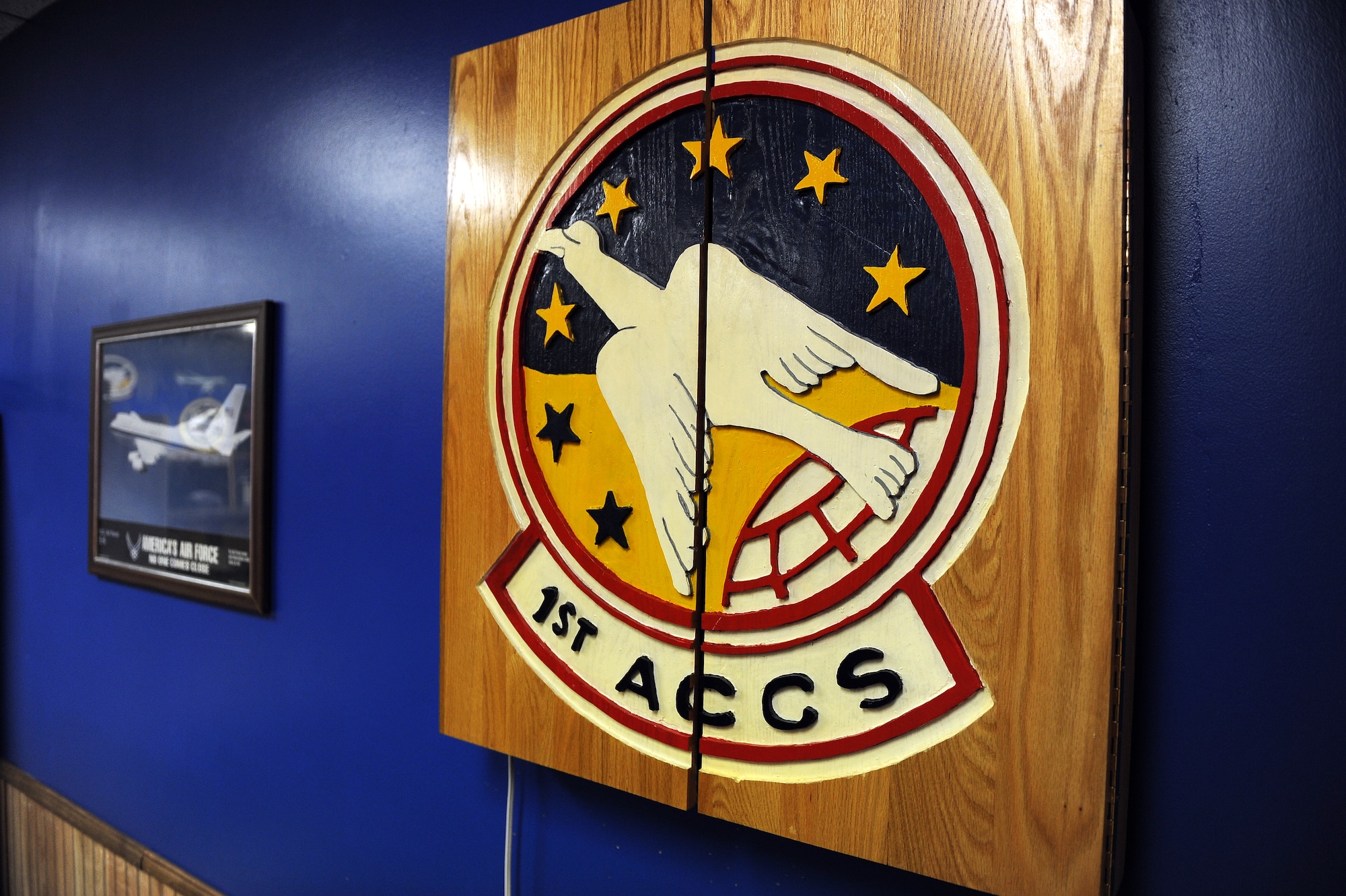 A hand-made, wooden dart board adorns the walls of the 1st Airborne Command Control Squadron’s heritage room located in the 55th Operations Support Squadron building on Jan. 13, Offutt Air Force Base, Neb.  The dart board was donated to the heritage room from an Airman’s father.  (U.S. Air Force photo by Josh Plueger/Released)