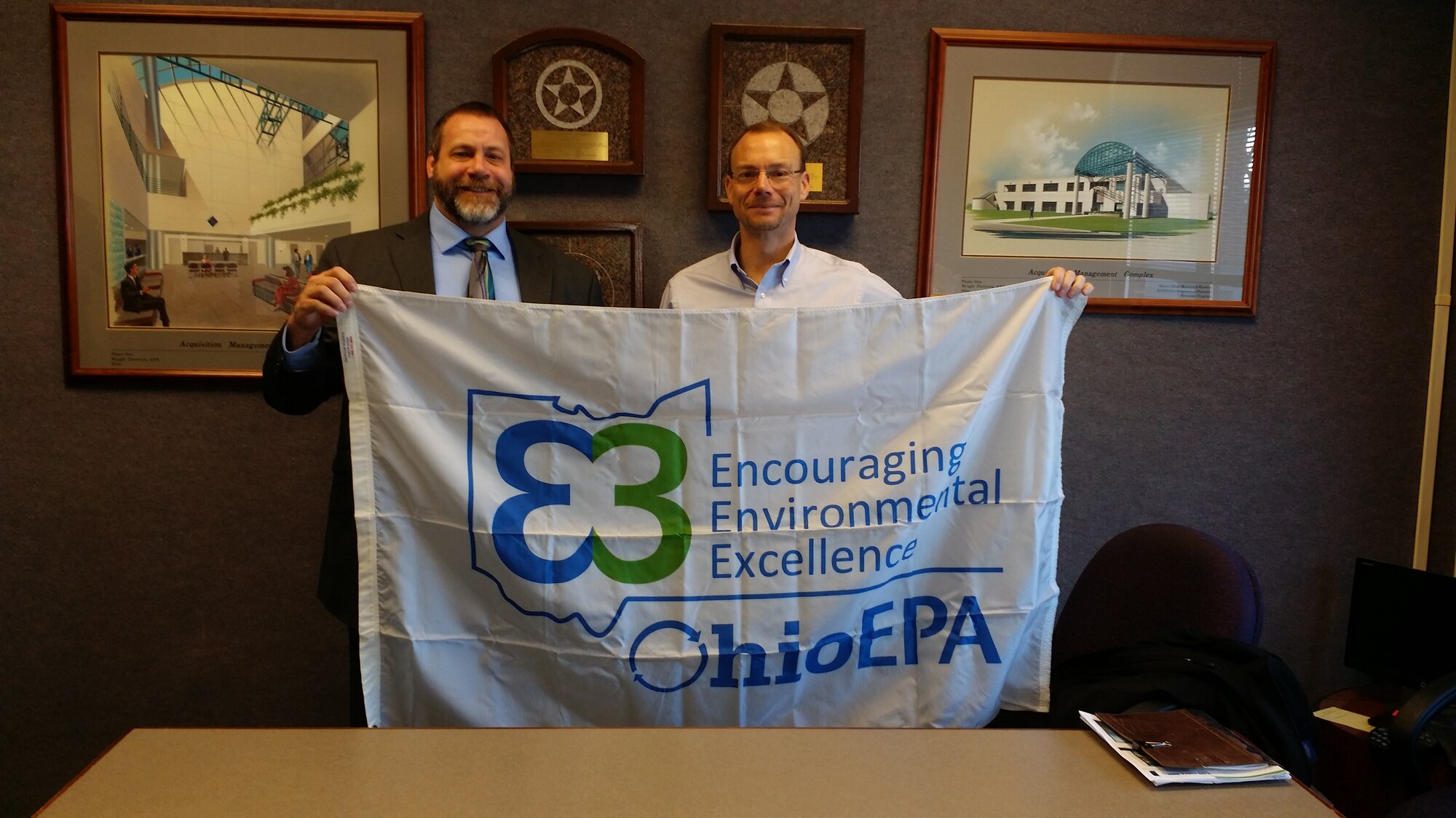 Ohio Environmental Protection Agency Director Craig Butler (right) presents the agency's silver-award under the Encouraging Environmental Excellency program to David Perkins, 88th Air Base Wing Civil Engineering director, during a base visit Jan. 13. (Ohio EPA photo)