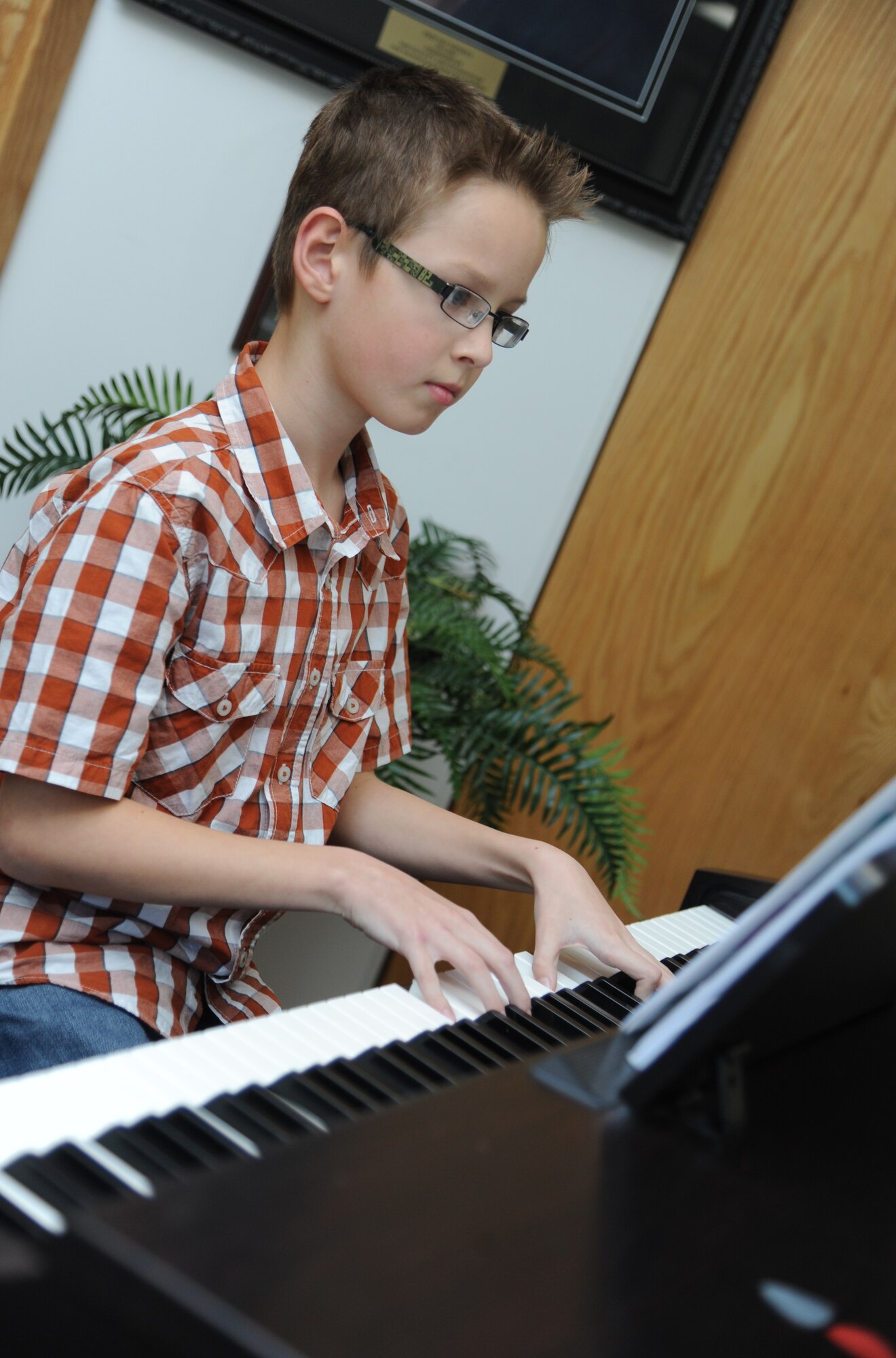 The son of Maj. Jeremiah Parker, 81st Dental Squadron resident, plays piano during a Biloxi Public School Board meeting Jan. 20, 2015, at the Dukate Building, Biloxi, Miss. The meeting was hosted by Jeff Davis Elementary School who selected talented children to perform for the board, which meets monthly. (U.S. Air Force photo by Kemberly Groue)