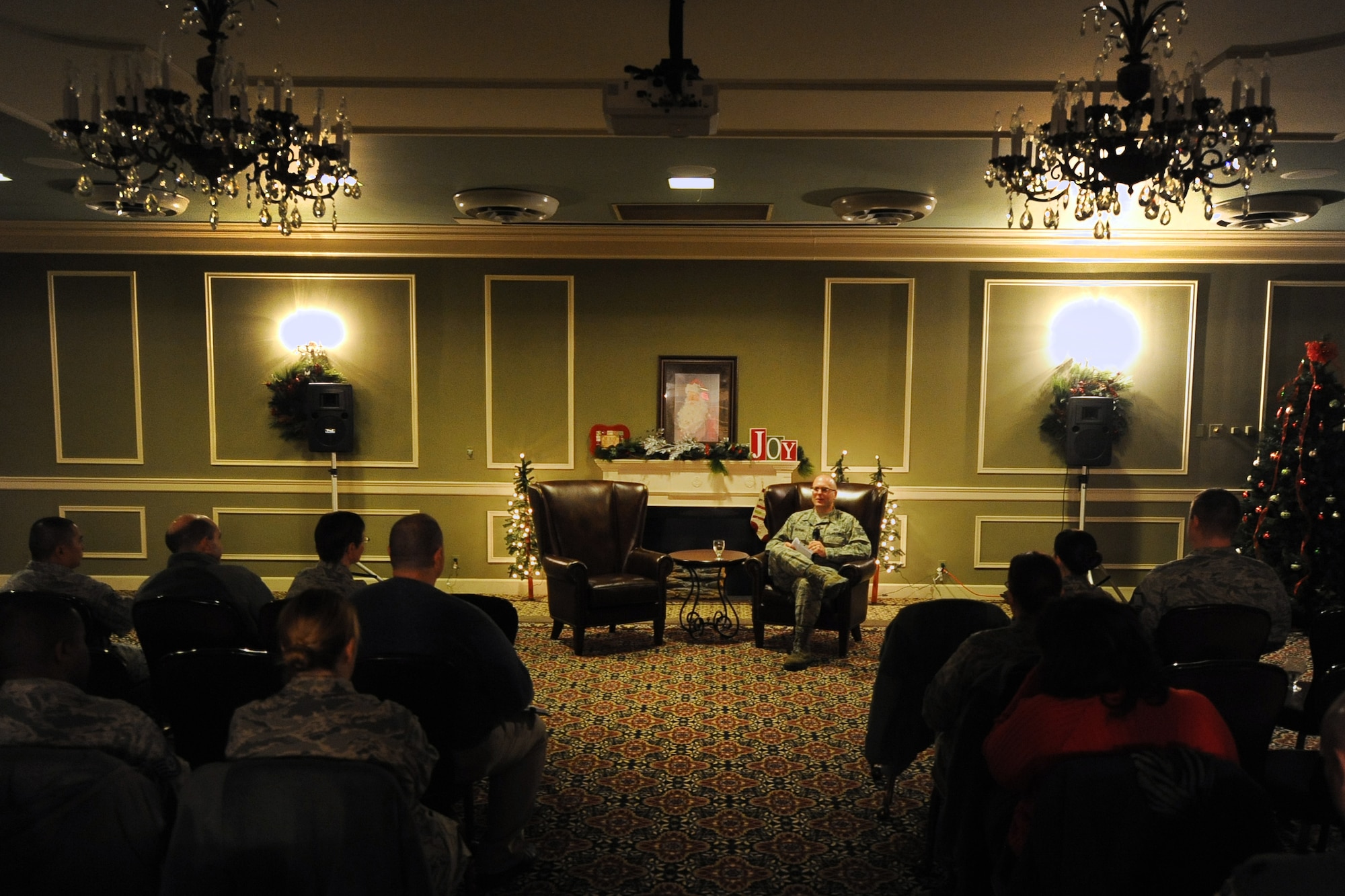 U.S. Air Force Tech. Sgt. Travis Williams, 55th Comptroller Squadron, sits in front of fellow Airman of Team Offutt while speaking about his experiences in a special duty assignment during the inaugural Story Tellers event called ‘The Long and Short of it’ held on Dec. 16 at the Patriot Club on Offutt Air Force Base, Neb. Williams stressed the importance of stepping outside of your comfort zone by looking into special duty assignments that the Air Force offers.  (U.S. Air Force photo by Josh Plueger/Released)