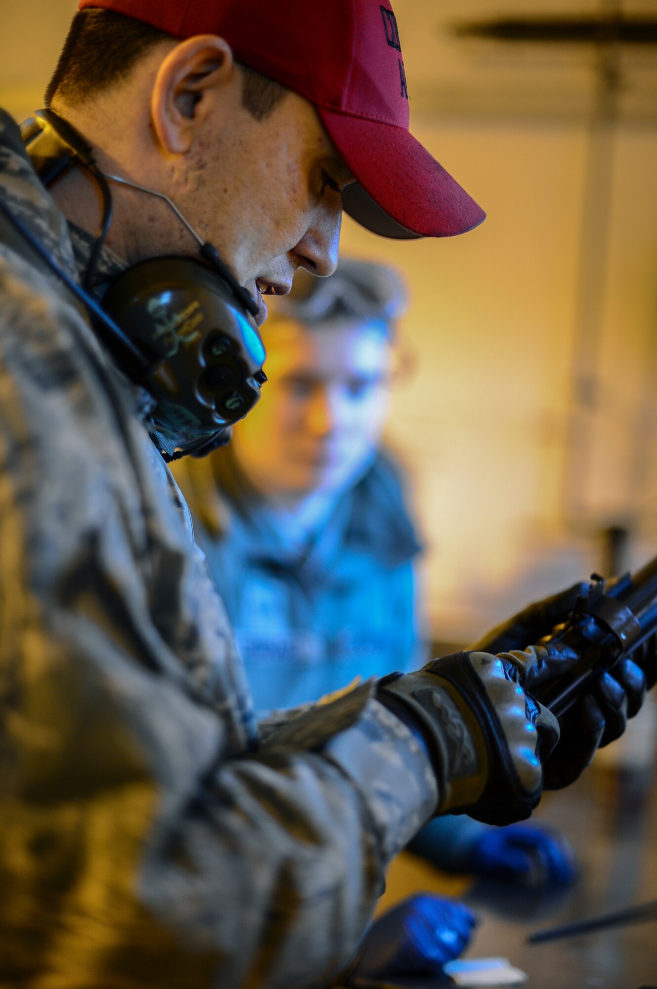 Staff Sgt. Alan Daly, 48th Security Forces Squadron combat arms instructor, demonstrates disassembly, inspection and cleaning of the M203 grenade launcher at Royal Air Force Feltwell, England, Dec. 12, 2014. Daly has been a Combat Arms Training and Maintenance instructor for more than a year. (U.S. Air Force photo by Airman 1st Class Erin R. Babis/Released)