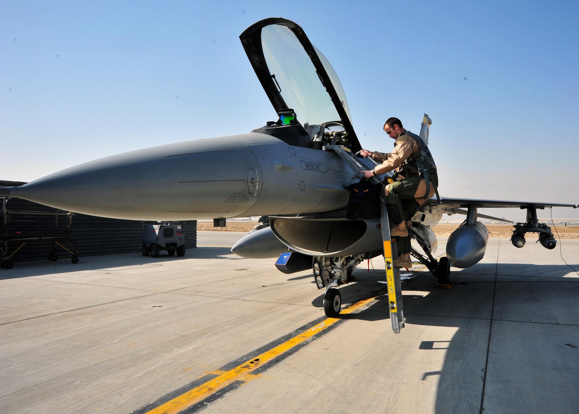 U.S. Air Force Capt. Shayne Carroll, 4th Expeditionary Fighter Squadron F-16 pilot, climbs a ladder leading to the cockpit of an F-16 Fighting Falcon in preparation for a mission Jan. 9, 2015 at Bagram Airfield, Afghanistan. The F-16 is a multi-role fighter aircraft that provides air superiority enabling freedom of movement for troops on the ground as well as close air support for troops engaged in combat. It provides a relatively low-cost, high-performance weapon system for the United States and allied nations. (U.S. Air Force photo by Staff Sgt. Whitney Amstutz)