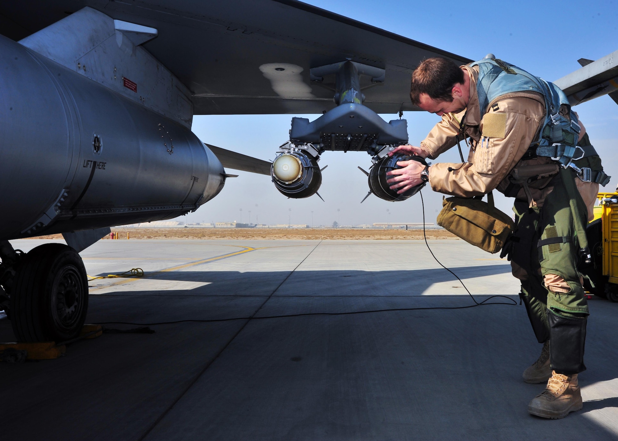 U.S. Air Force Capt. Shayne Carroll, 4th Expeditionary Fighter Squadron F-16 pilot, inspects an F-16 Fighting Falcon prior to a mission Jan. 9, 2015 at Bagram Airfield, Afghanistan. The F-16 is a multi-role fighter aircraft that provides air superiority enabling freedom of movement for troops on the ground as well as close air support for troops engaged in combat. It provides a relatively low-cost, high-performance weapon system for the United States and allied nations. (U.S. Air Force photo by Staff Sgt. Whitney Amstutz)