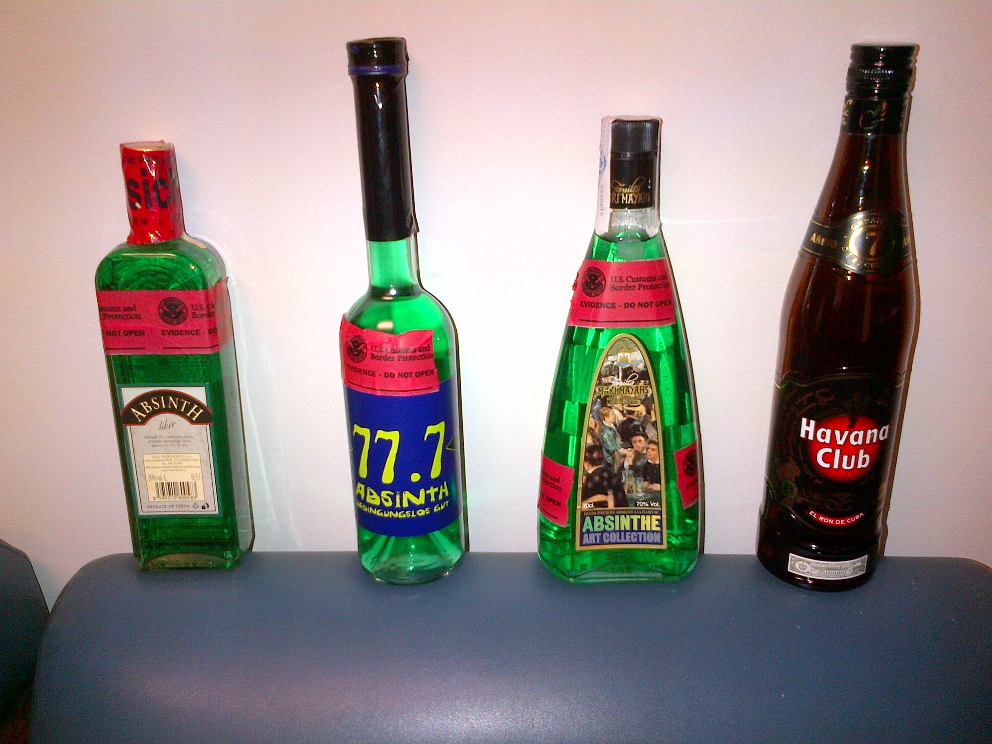 Three bottles of absinth and a bottle of Cuban rum sit on display Jan. 21, 2015, inside the U.S. Customs and Border Protection office on Dover Air Force Base, Del. These bottles were confiscated by Customs and Border Protection officers. (Courtesy photo)