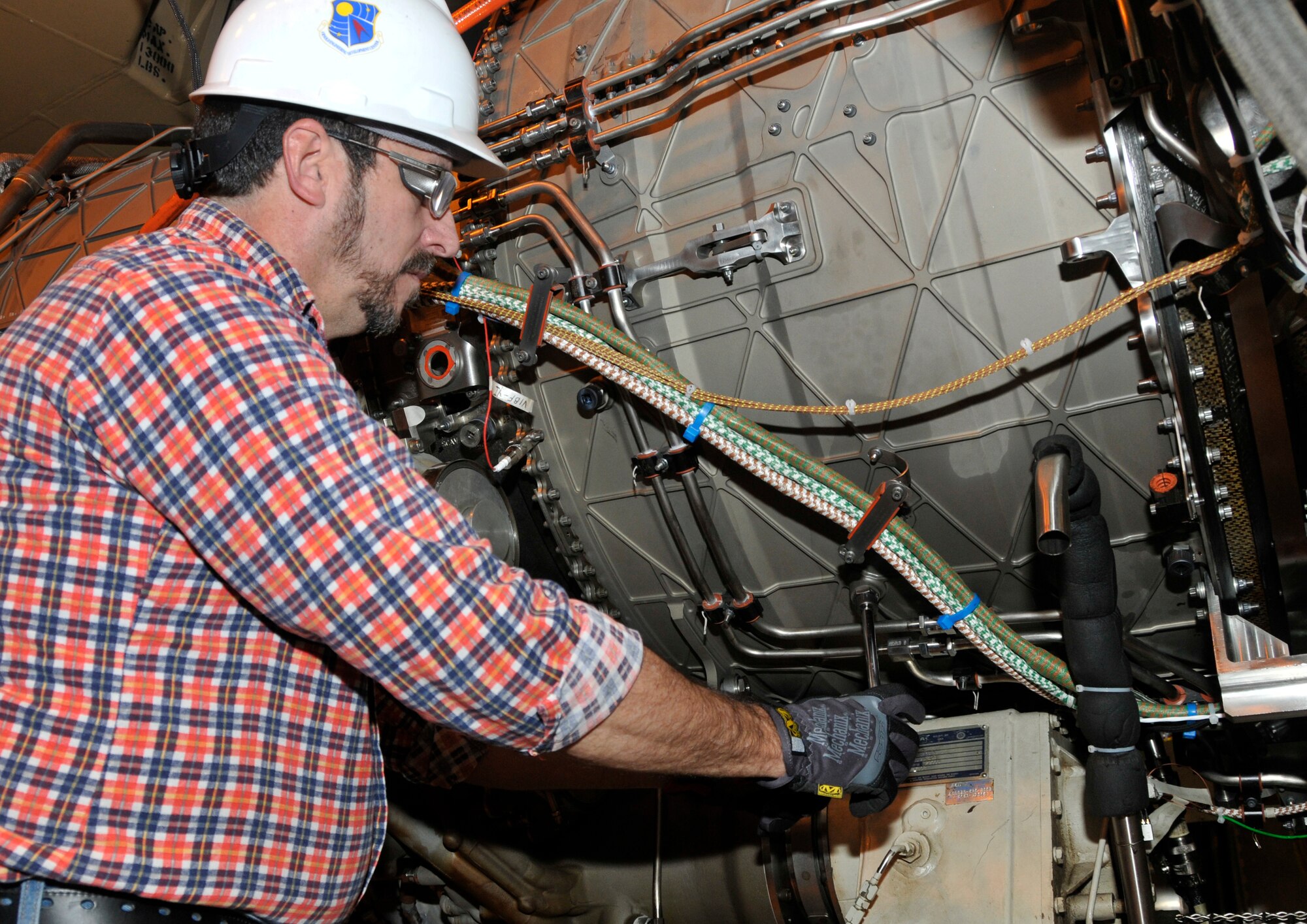 Aerospace Testing Alliance mechanic Jim Atkielski replaces the borescope plug following a borescope inspection of the F135-PW-100 CTOL/CV. (Photo by Jacqueline Cowan)
