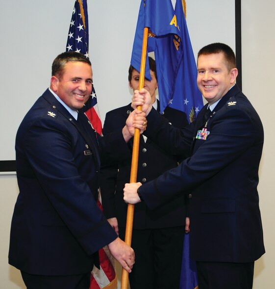 WRIGHT-PATTERSON AIR FORCE BASE, Ohio – Col. Jeffrey S. Beery accepts the 445th Aeromedical Staging Squadron guidon from Col. Michael Major, 445th Airlift Wing commander, during the Dec. 6, 2014 assumption of command ceremony. Beery was previously assigned to the 445th Aerospace  Medicine Squadron where he was the chief of aerospace medicine. (U.S. Air Force photo/Tech. Sgt. Patrick O’Reilly)
