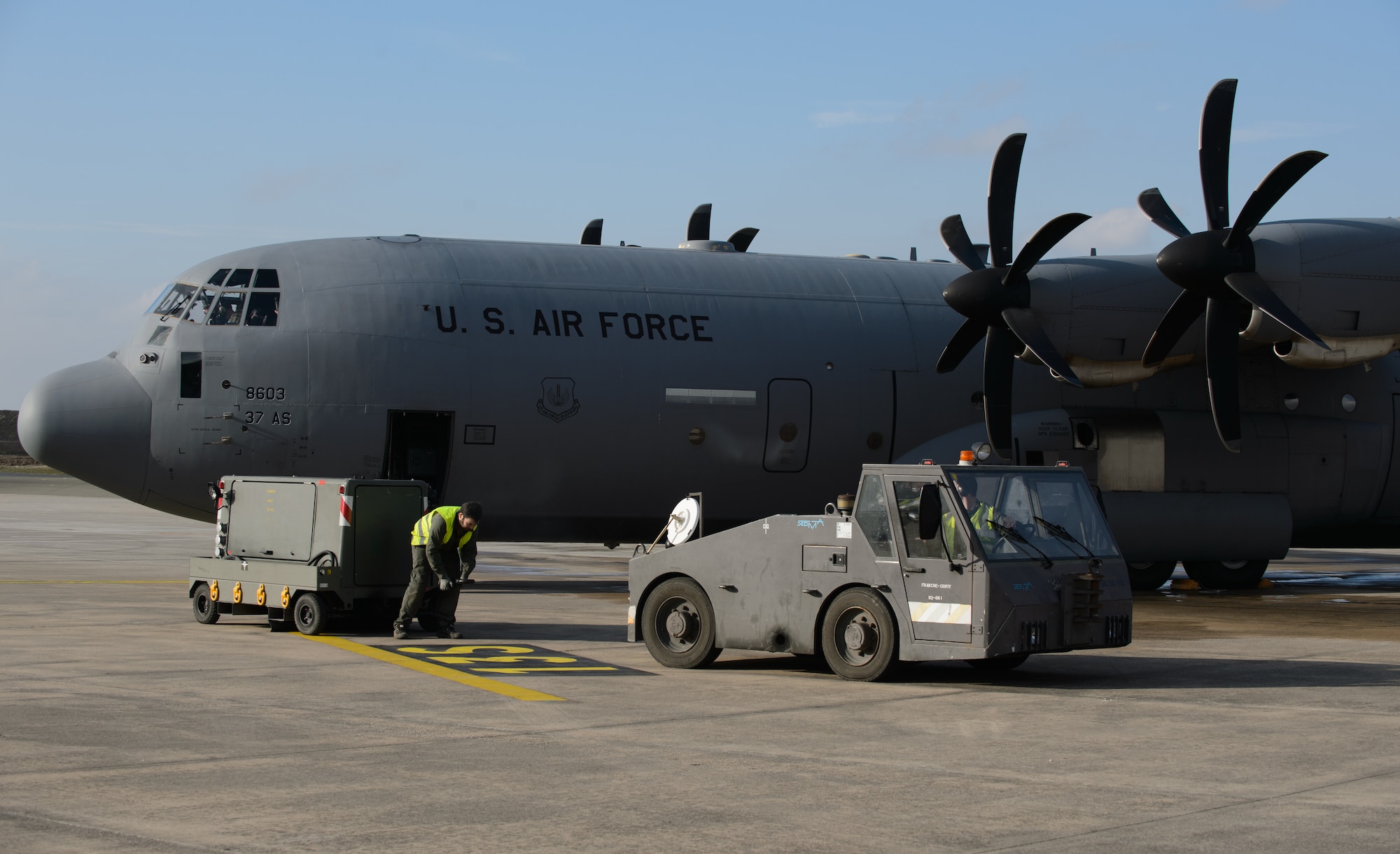 French maintainers retrieve a power cart prior to an U.S. C-130J Super Hercules taking off at Orleans - Bricy Air Base, France, Jan. 21, 2015. Two C-130Js were led by a French C-130H Hercules as part of the French led exercise Volfa 15-1. (U.S. Air Force photo/Senior Airman Armando A. Schwier-Morales)