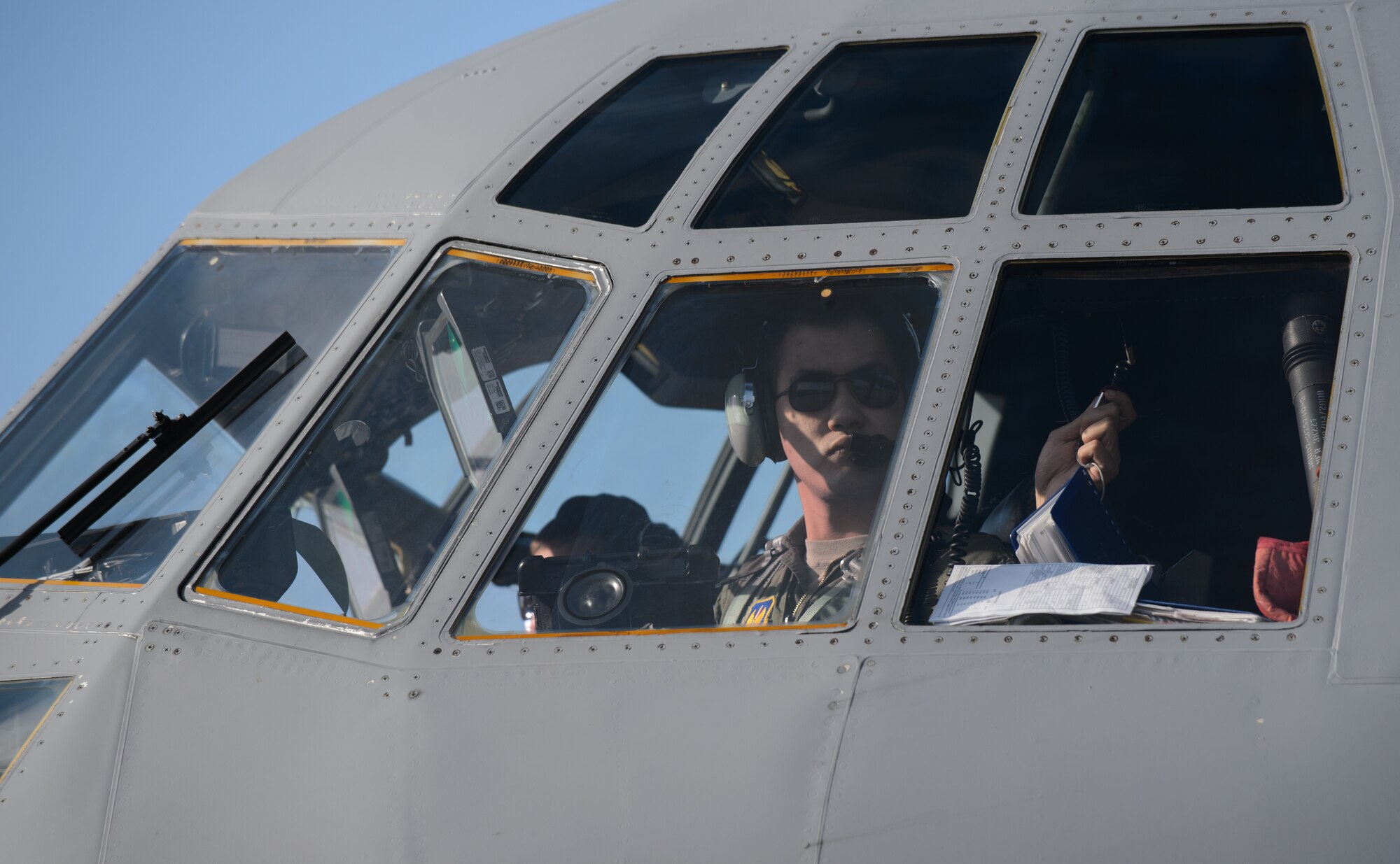 Capt. Isaac Leung, 37th Airlift Squadron pilot, grabs his checklist as he prepares for a flight with French Airmen at Orleans - Bricy Air Base, France, Jan. 21, 2015. Leung participated in a simulated low-level drop led by a French C-130H Hercules as part of exercise Volfa 15-1. (U.S. Air Force photo/Senior Airman Armando A. Schwier-Morales)