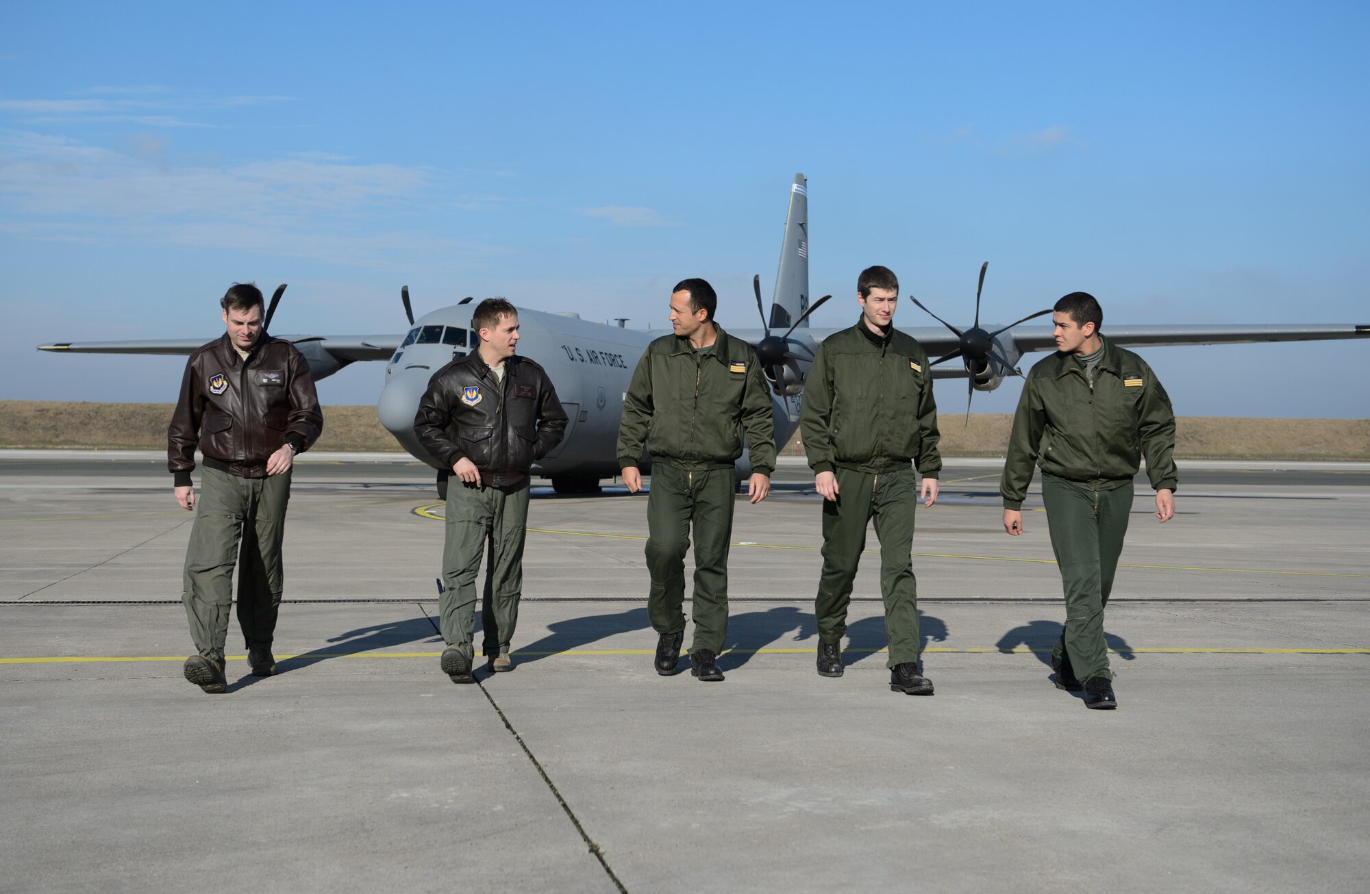 French and U.S. pilots walk back to a hangar after sharing experiences gathered flying the C-130J Super Hercules at Orleans - Bricy Air Base, France, Jan. 21, 2015. Two U.S. C-130s supported exercise Volfa 15-1 in order to develop and hone coalition skills. (U.S. Air Force photo/Senior Airman Armando A. Schwier-Morales)