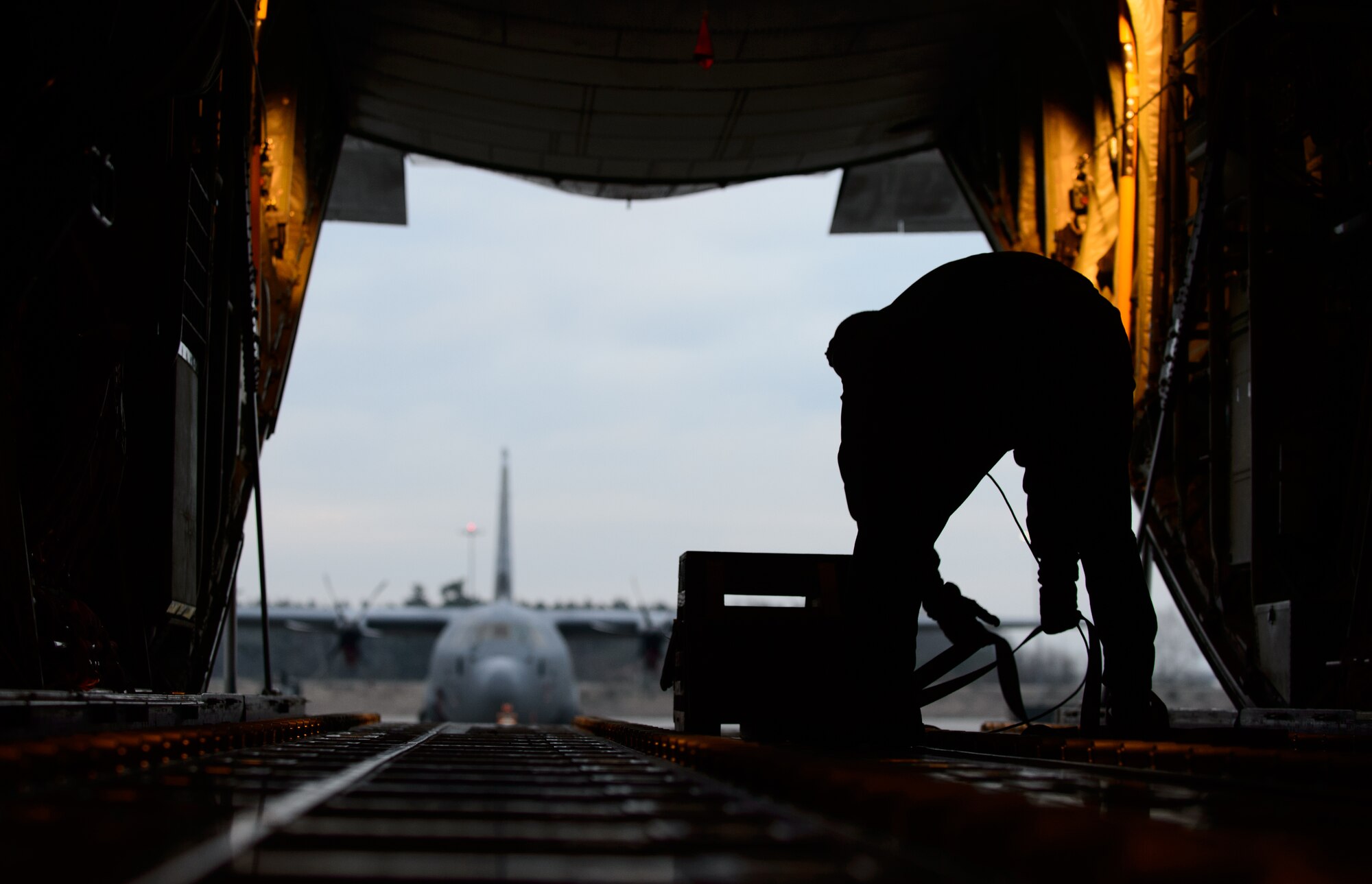 Tech. Sgt. James Moenning, 37th Airlift Squadron loadmaster, ties down gear prior to take off at Ramstein Air Base, Germany, Jan. 21, 2015. Two C-130J Super Hercules joined a French C-130H Hercules to develop the allies’ ability to work together during exercise Volfa 15-1. (U.S. Air Force photo/Senior Airman Armando A. Schwier-Morales)