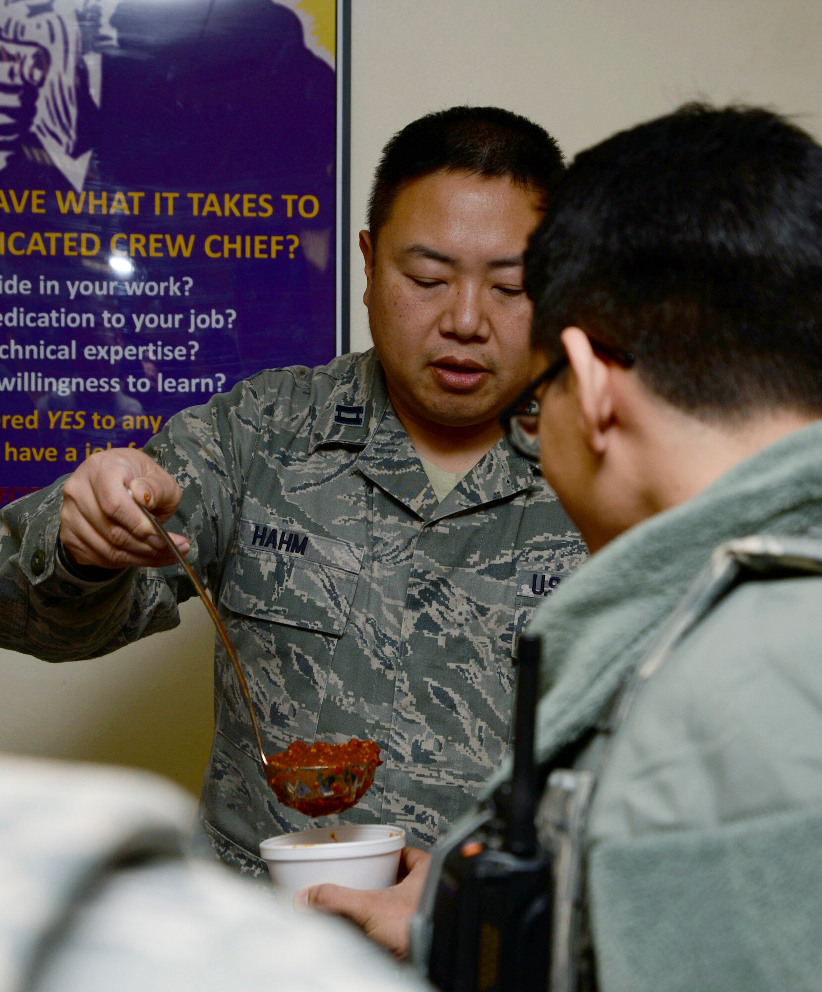 U.S. Air Force Chaplain (Capt.) Henry Hahm, 100th Air Refueling Wing chaplain from Westbury, N.Y., serves chili to night shift workers Jan. 23, 2015, on RAF Mildenhall, England. The RAF Mildenhall Chapel and volunteers served food from approximately 11 p.m. until 12:30 a.m. (U.S. Air Force photo by Senior Airman Victoria H. Taylor/Released)