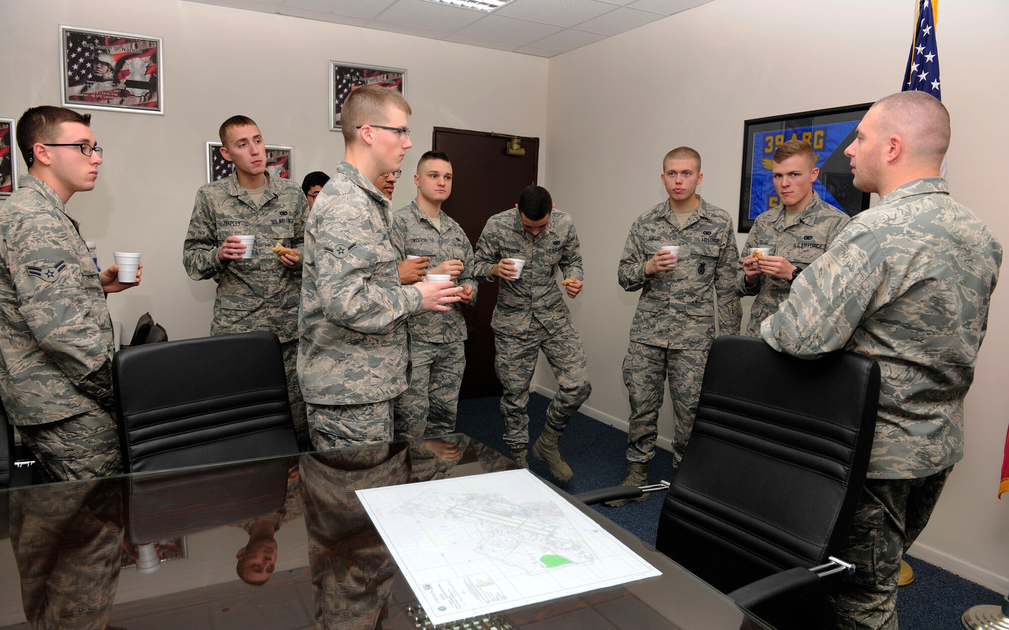 Airmen from the 39th Security Forces Squadron speak with Capt. (Chap) Brent Mulder, 39th Air Base Wing base chapel, while eating cookies and hot chocolate Jan. 23, 2015, at Incirlik Air Base, Turkey. Members of the chapel and several first sergeants spent the morning surprising multiple squadrons around the base with cookies and hot chocolate. (U.S. Air Force photo by Senior Airman Krystal Ardrey/Released)