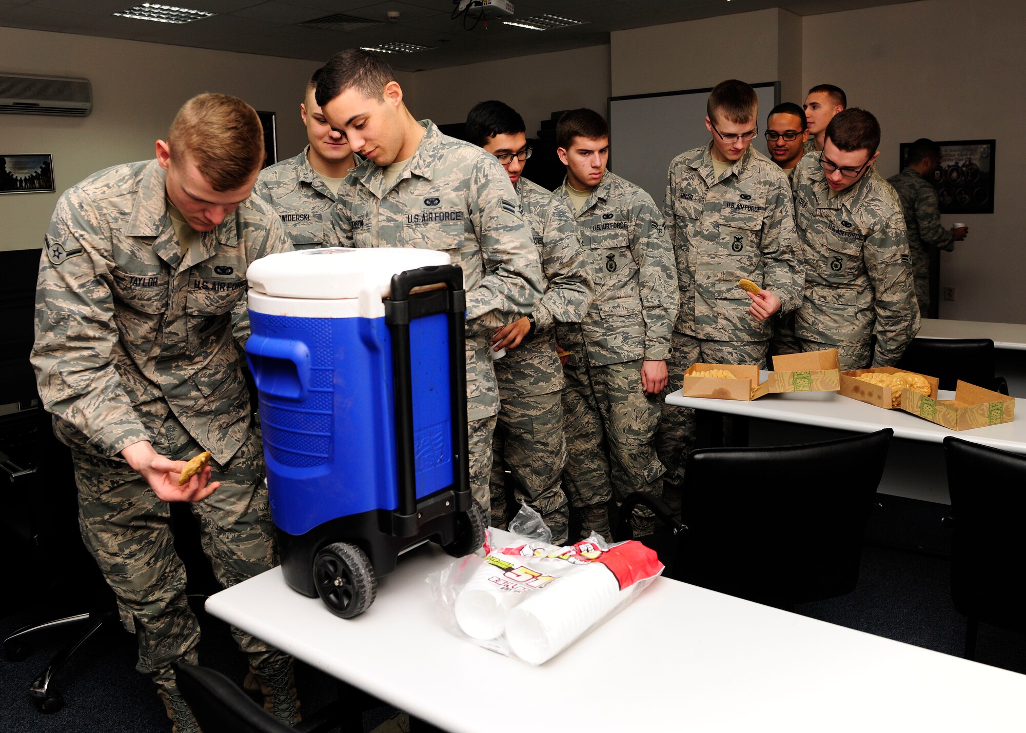 Airmen from the 39th Security Forces Squadron are given cookies and hot chocolate as part of a morale event Jan. 23, 2015, at Incirlik Air Base, Turkey. Members from the base chapel and the First Sergeants group delivered the cookies and hot chocolate to multiple units throughout the morning. (U.S. Air Force photo by Senior Airman Krystal Ardrey/Released)