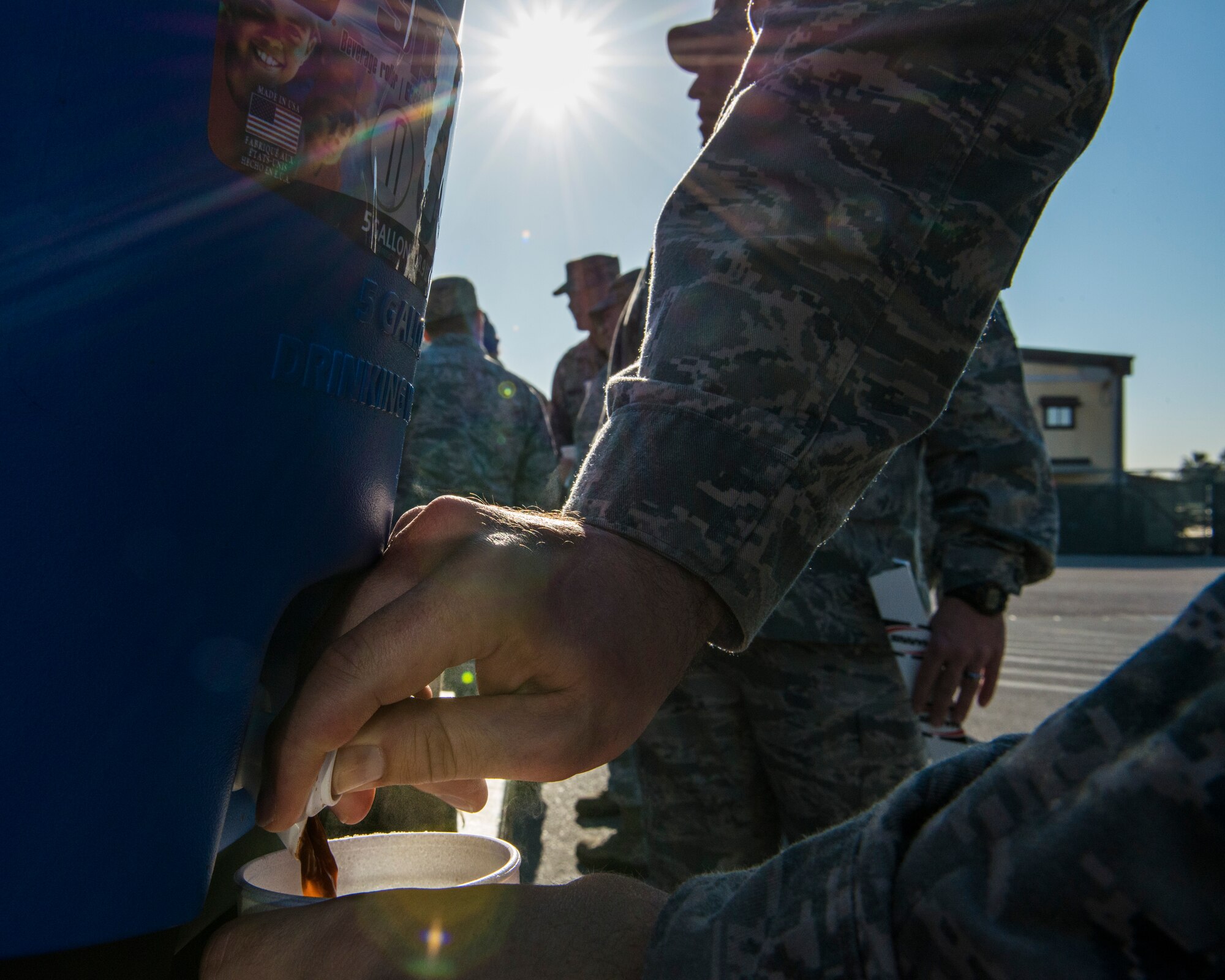 Master Sgt. Jason Chiasson, 728th Air Mobility Squadron first sergeant, pours hot chocolate for an Airman during a random acts of kindness event Jan. 23, 2015, at Incirlik Air Base, Turkey. The first sergeants served more than 15 gallons of hot chocolate and 500 cookies to units throughout base. (U.S. Air Force photo by Airman Cory W. Bush/Released)