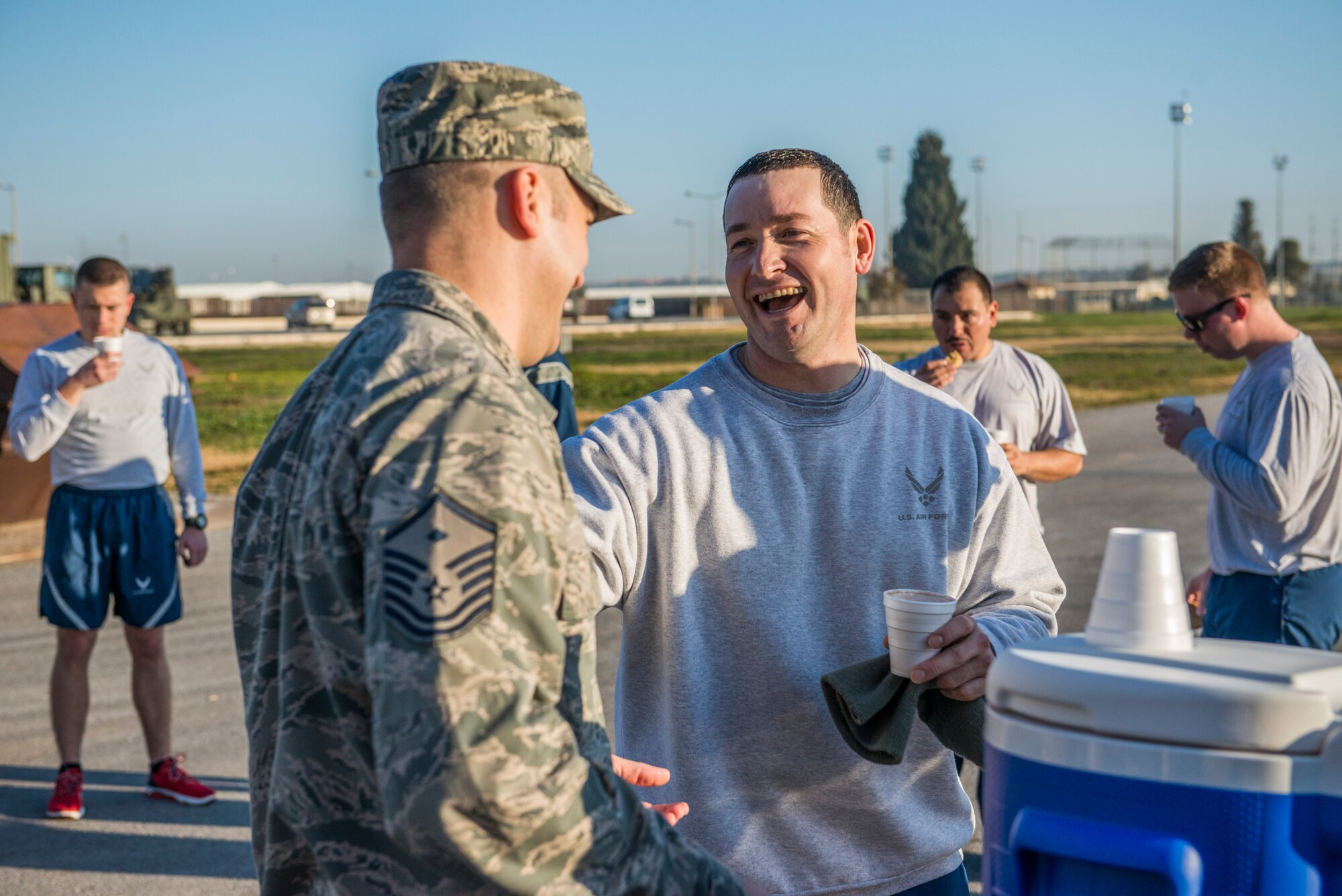 Master Sgt. Bryan Bennett, 728th Air Mobility Squadron quality assurance manager, converses with Master Sgt. Andrew Flora, 39th Logistics Readiness Squadron first sergeant, during a random acts of kindness event Jan. 23, 2015, at Incirlik Air Base, Turkey. As part of the event, first sergeants and members of the chapel pass out hot chocolate and cookies to different units across the base. (U.S. Air Force photo by Airman Cory W. Bush/Released)