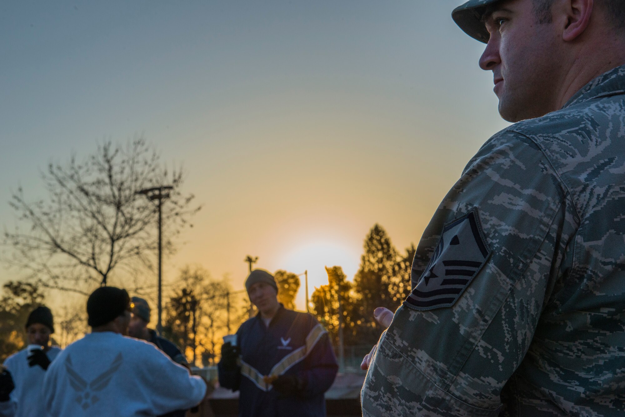Master Sgt. Andrew Flora, 39th Logistics Readiness Squadron first sergeant, looks on Airmen during a random acts of kindness event Jan. 23, 2015, at Incirlik Air Base, Turkey. As a morale event, first sergeants and members of the base chapel, surprised units with a delivery of hot chocolate and cookies. (U.S. Air Force photo by Airman Cory W. Bush/Released)