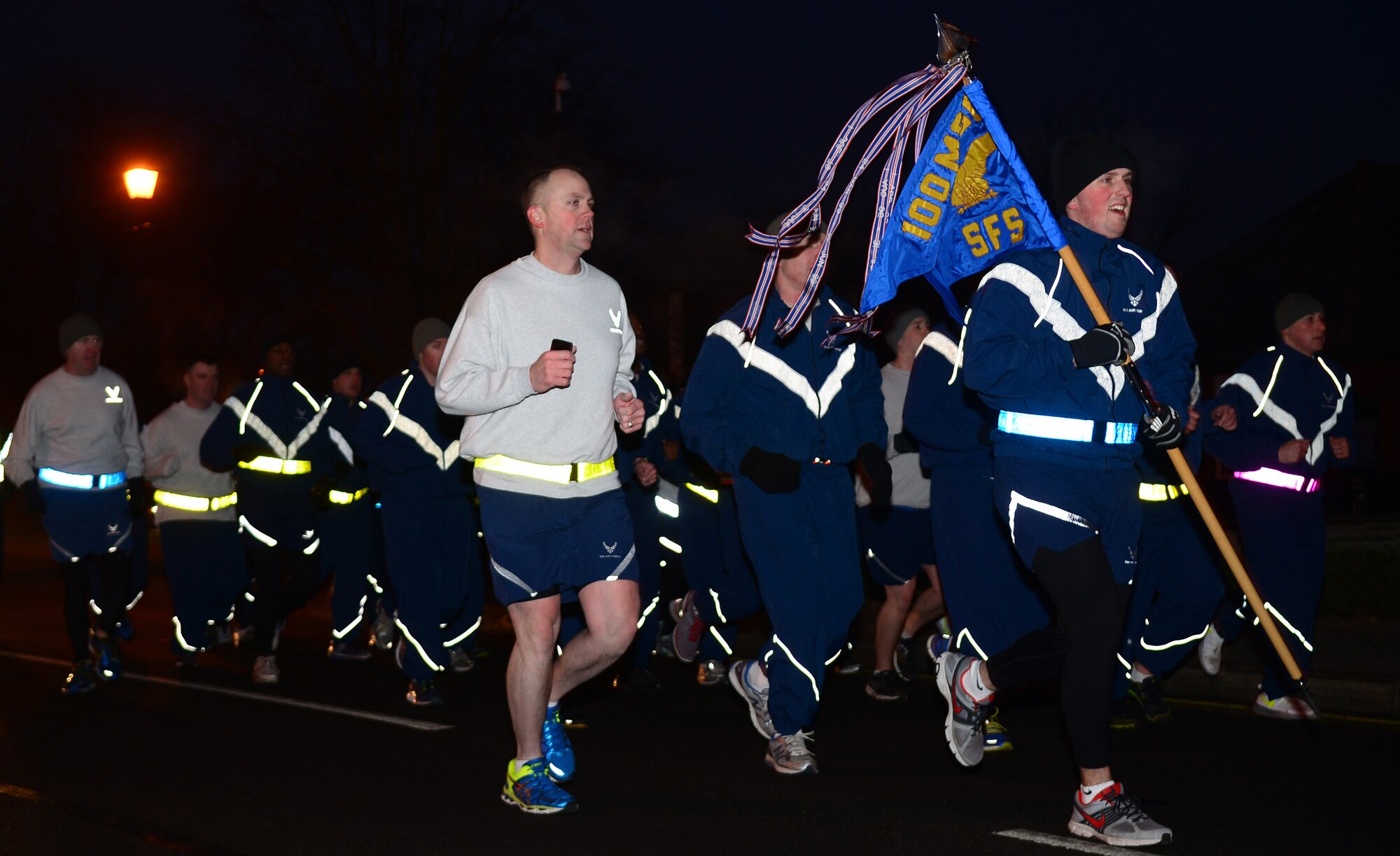 U.S. Air Force Airmen from the 100th Security Forces Squadron run in formation Jan. 23, 2015, on RAF Mildenhall. During the monthly 100th Air refueling Wing’s training days, the 100th SFS holds a formation run as a moral building exercise. (U.S. Air Force photo by Airman 1st Class Jonathan Light/Released)