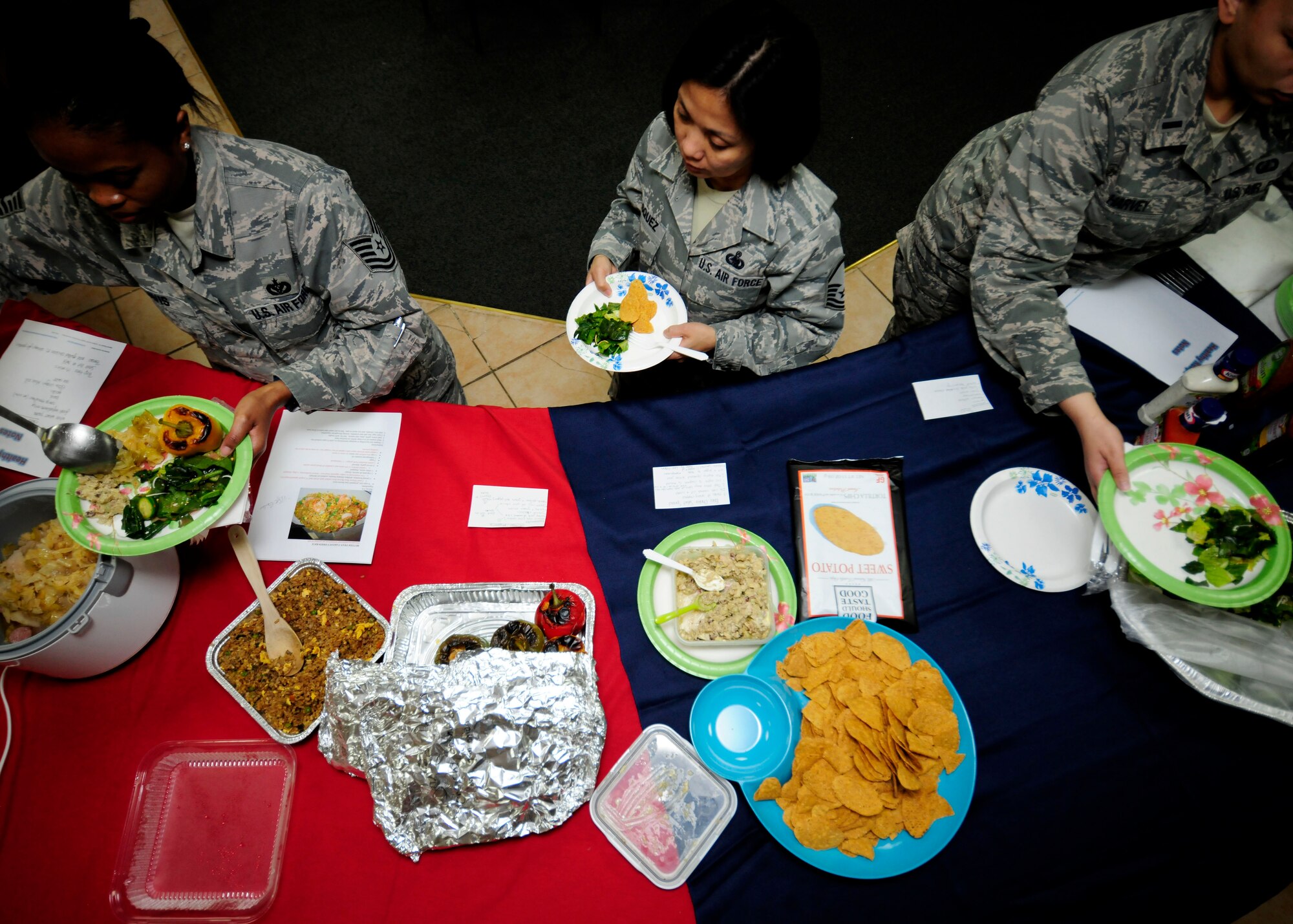 Airmen attending the Women’s Diversity Council “New Year, New You” luncheon serve themselves healthy food Jan. 22, 2015, at Incirlik Air Base, Turkey. The luncheon featured a potluck-style lunch with guest speakers from the Women, Infants and Children Overseas Program and the Health and Wellness Center. (U.S. Air Force photo by Senior Airman Krystal Ardrey/Released)