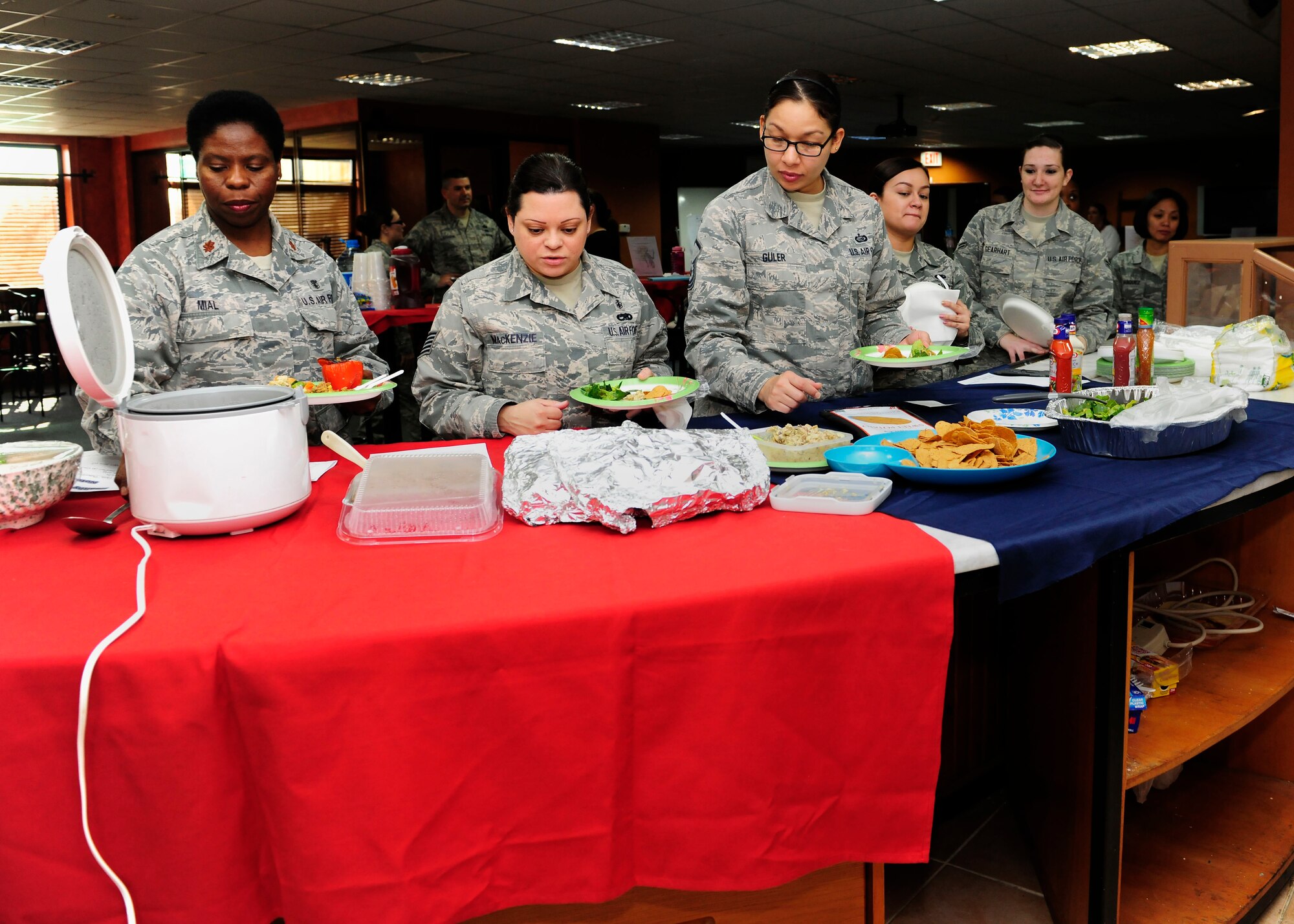 Airmen of a Women’s Diversity Council “New Year, New You” luncheon serve themselves healthy food Jan. 22, 2015, at Incirlik Air Base, Turkey. During the event attendees listened to guest speakers from the Women, Infants and Children Overseas Program and the Health and Wellness Center. (U.S. Air Force photo by Senior Airman Krystal Ardrey/Released)