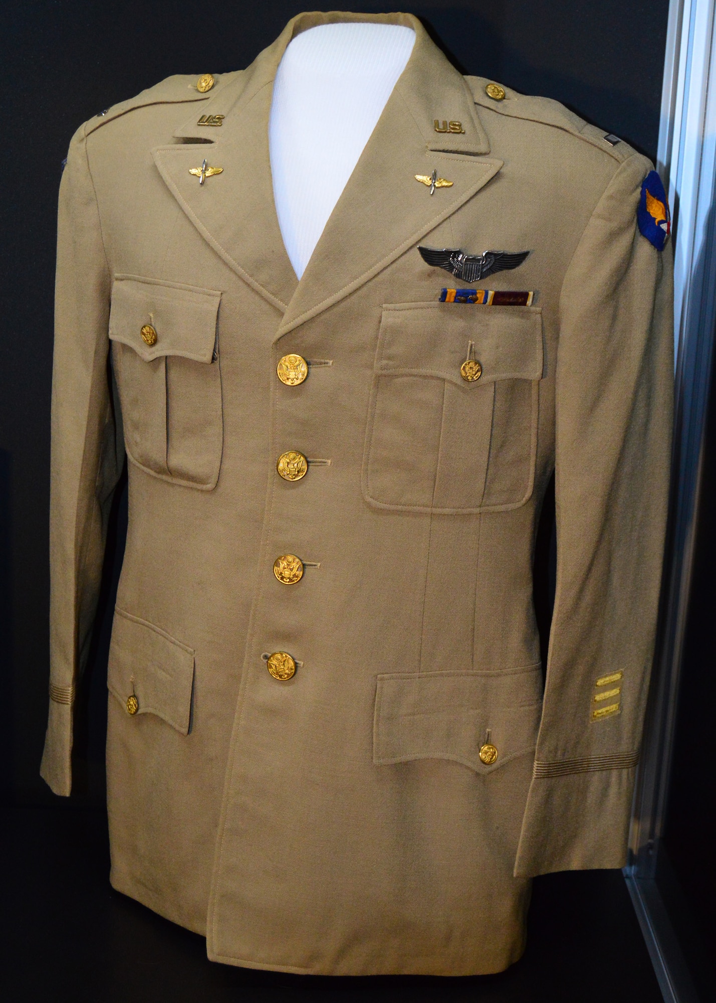 DAYTON, Ohio -- Service coat with the Twelfth Air Force emblem, pilot wings, medal ribbons, and three service stripes belonging to 1st Lt John L. Hamilton.  A pilot with the 99th Fighter Squadron, he received the Purple Heart after being wounded in the leg by flak during a dive-bombing mission at Anzio on March 9, 1944.  [Please note that the “U.S.” lapel and rank insignia have been added to complete the uniform.] This service coat is on display in the Tuskegee Airmen Exhibit in the WWII Gallery at the National Museum of the U.S. Air Force. (U.S. Air Force photo)