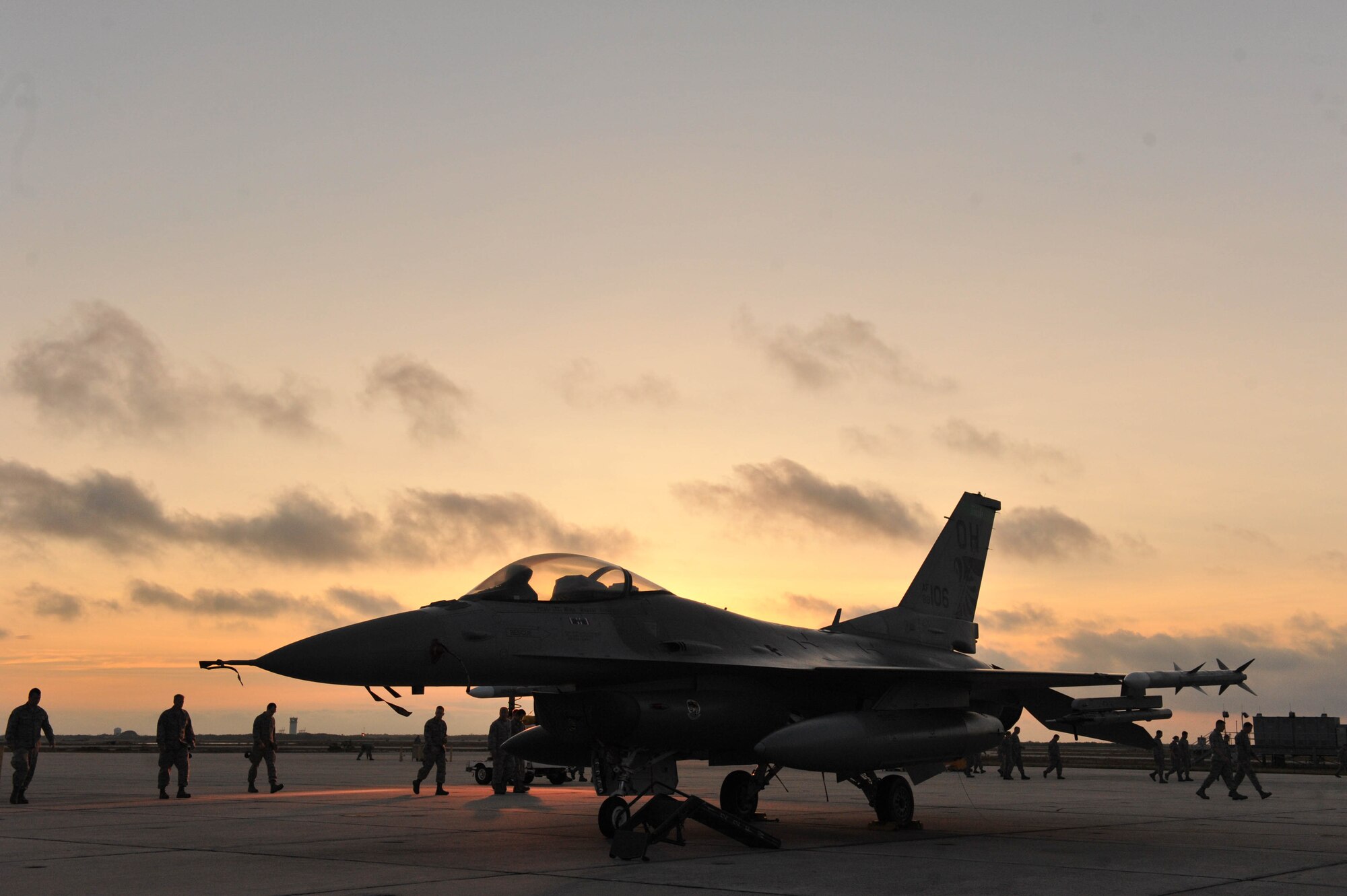 U.S. Air Force Airmen from the 180th Fighter Wing conduct a foreign object debris search, commonly referred to a FOD walk, during sunrise on the flight line of Naval Station Key West, Boca Chica Island, Florida.  FOD consists of loose objects like rocks and sticks and FOD walks helps to minimize unnecessary damage to the engine of a fighter aircraft. (Air National Guard photo by Staff Sgt. Amber Williams/Released)